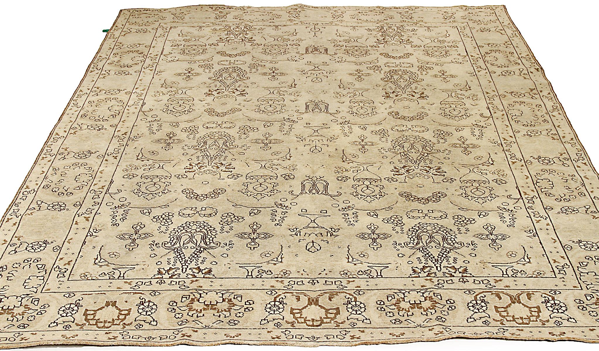 Antique Persian rug handwoven from the finest sheep’s wool and colored with all-natural vegetable dyes that are safe for humans and pets. It’s a traditional Tabriz weaving featuring a lovely ensemble of floral designs outlined in black with hints of