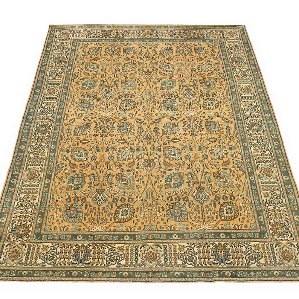Antique Persian rug handwoven from the finest sheep’s wool and colored with all-natural vegetable dyes that are safe for humans and pets. It’s a traditional Tabriz weaving featuring a lovely ensemble of floral and botanical designs in brown and blue