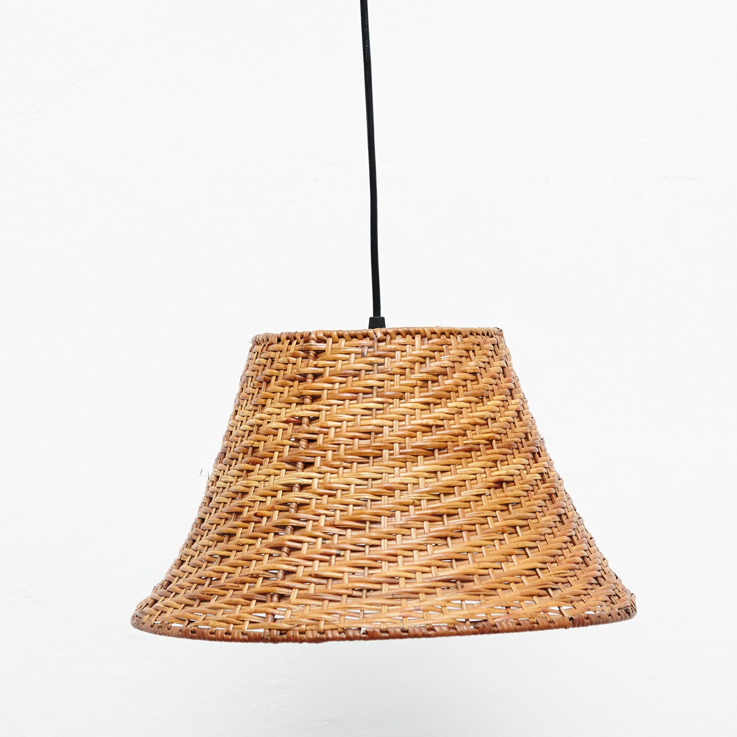 20th century antique Rattan ceiling lamp.
By unknown manufacturer, Spain.

In original condition, with minor wear consistent with age and use, preserving a beautiful patina.

Materials:
Rattan

Dimensions:
ø 35 cm x H 21 cm.