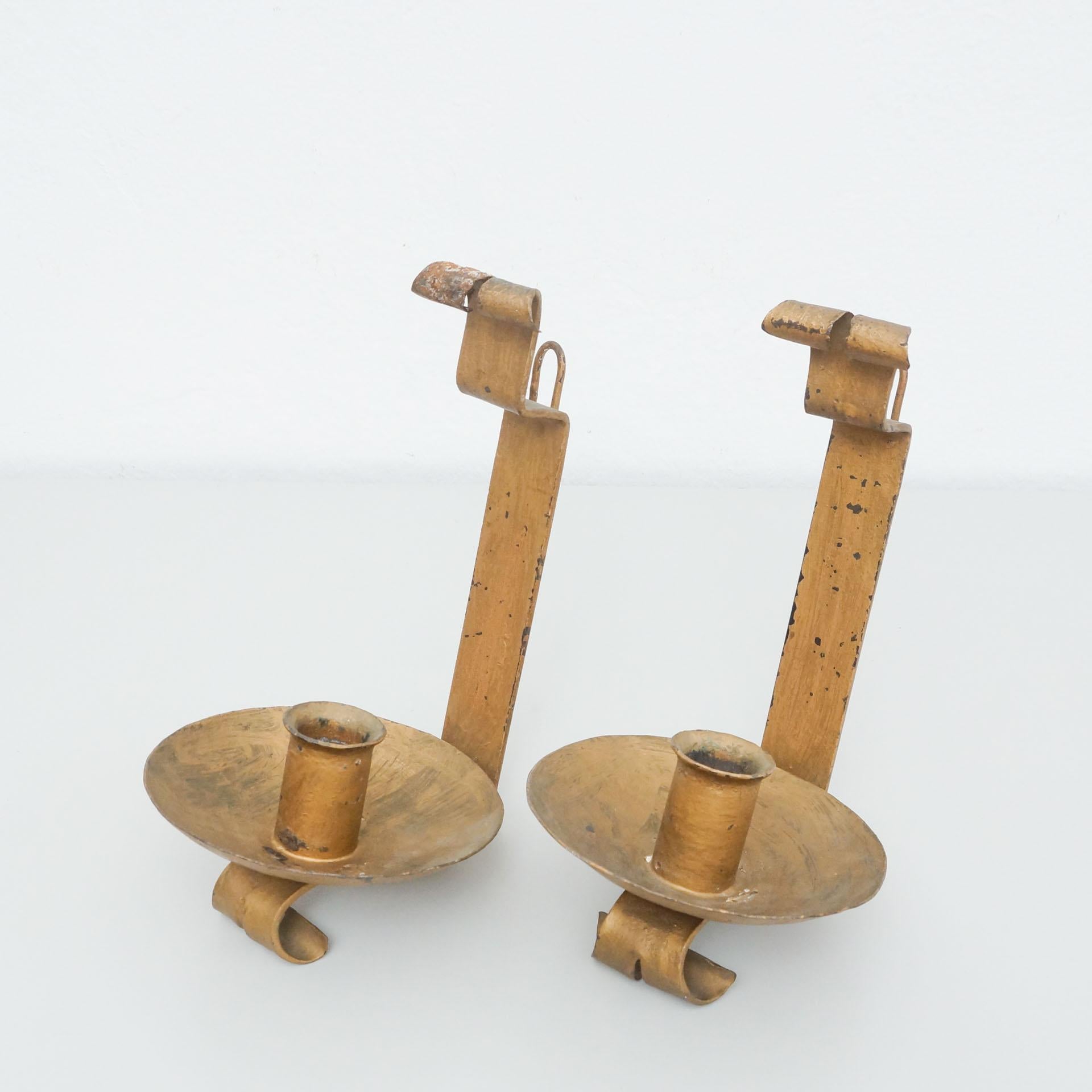 Set of two wall chandeliers for candles, circa 20th century.
By unknown manufacturer, Spain.

In original condition, with minor wear consistent with age and use, preserving a beautiful patina.

Materials:
Metal

Dimensions:
D 19 cm x W 17