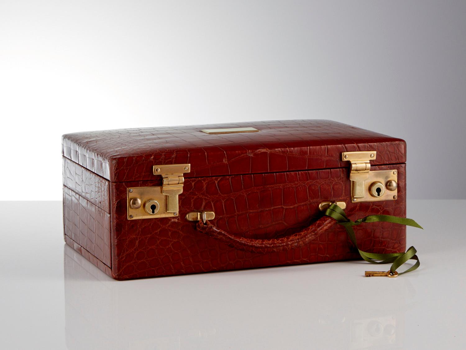 An Antique 20th Century London Tan Crocodile jewel box with lift tray opening, circa 1920

Beautifully matched crocodile skins have been used on this jewel box both the exterior and interior are in fantastic order.
When opened there are lifting and