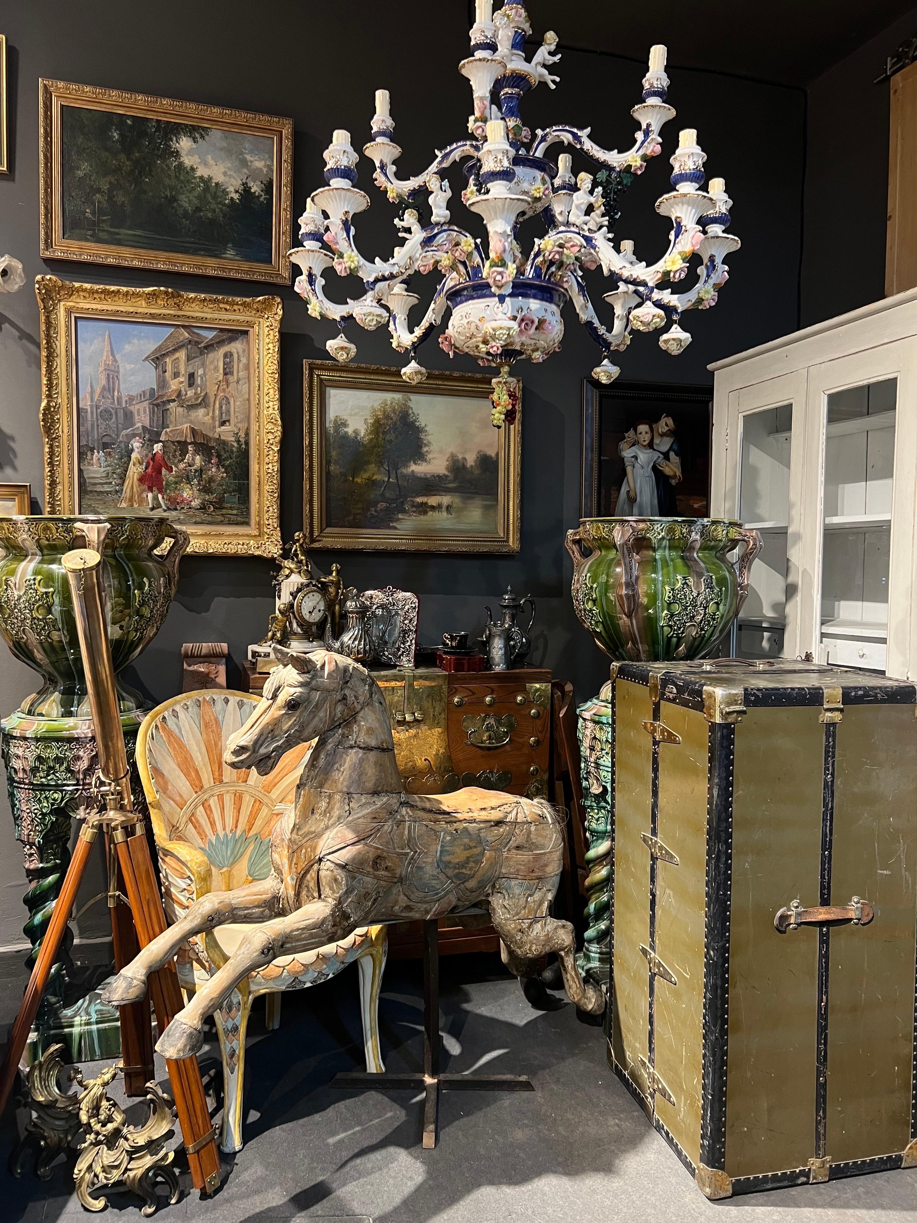 This large green steamer chest is made by Madler Koffer in the early 20th century and have been travel a lot. The wardrobe offers a hanging garment section with wooden hangers and five drawers on the right side in different sizes. It is in authentic