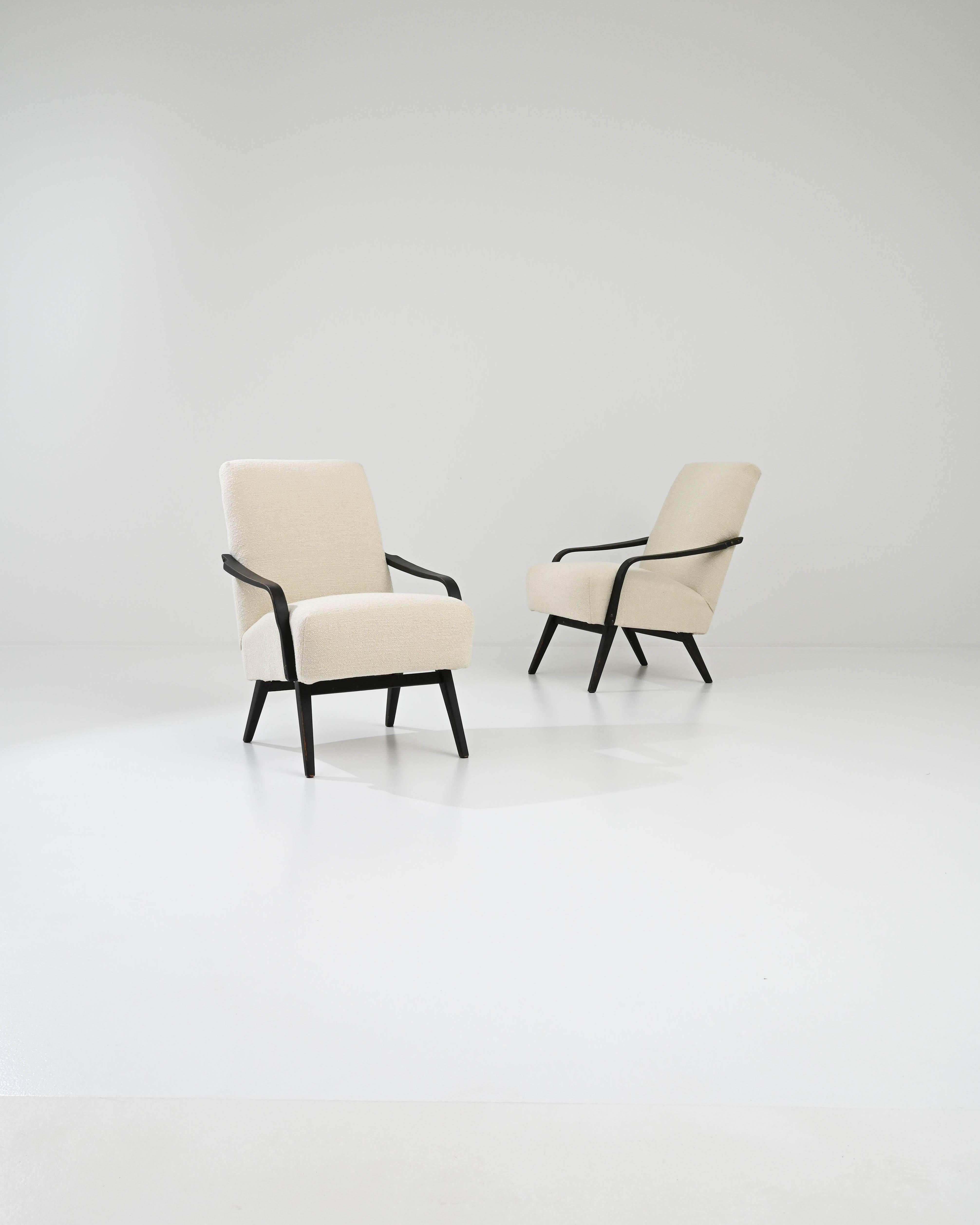 This beautiful pair of Mid-Century Modern armchairs were made in Czechia by renowned furniture manufacturers TON, design attributed to J. Smidek. Low-set and comfortable, a deep seat upholstered in soft boucle is set at a gentle recline. Sloping