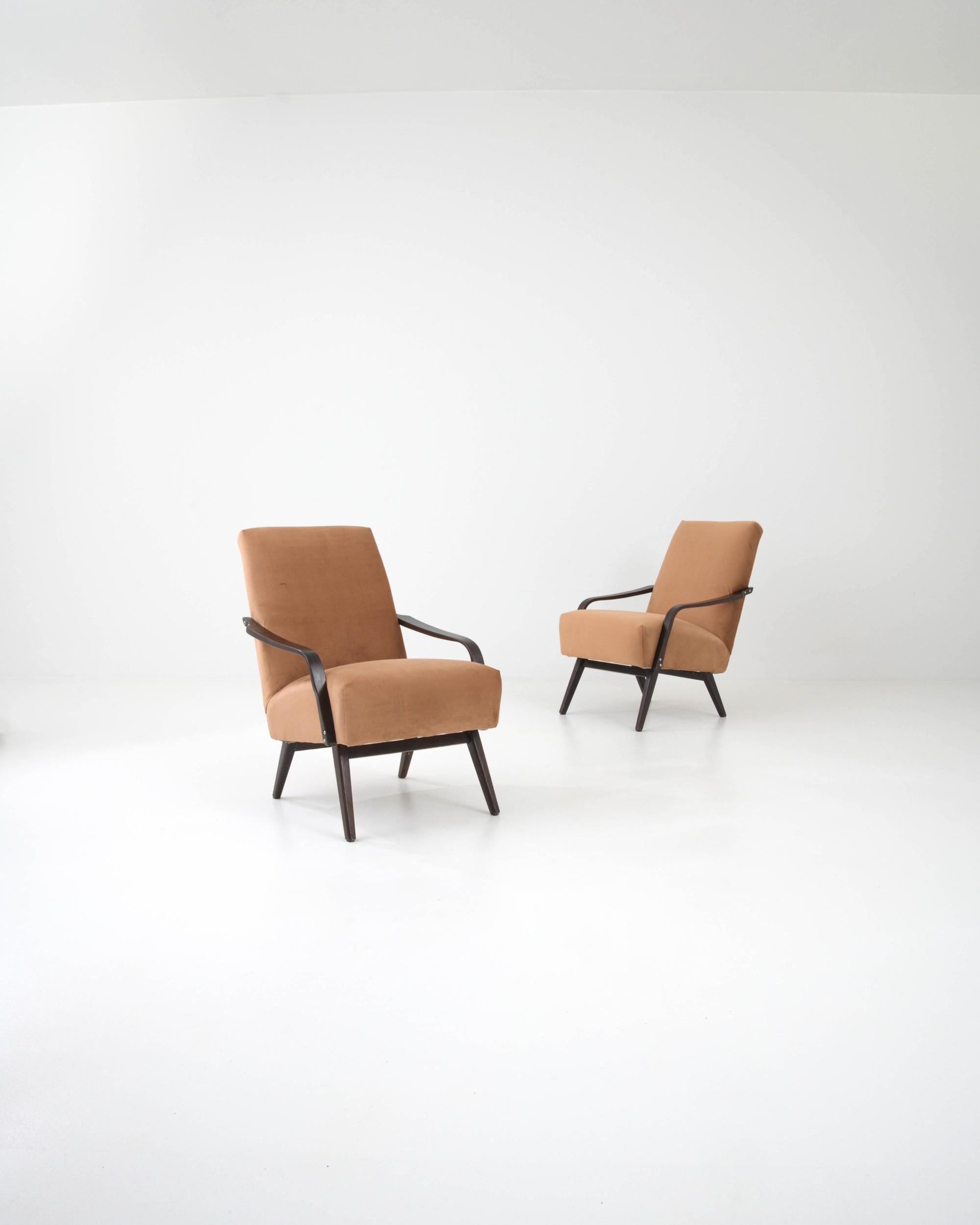 This beautiful pair of Mid-Century Modern armchairs were made in Czechia by renowned furniture manufacturers TON, design attributed to J. Smidek. Low-set and comfortable, a deep seat upholstered in soft boucle is set at a gentle recline. Sloping