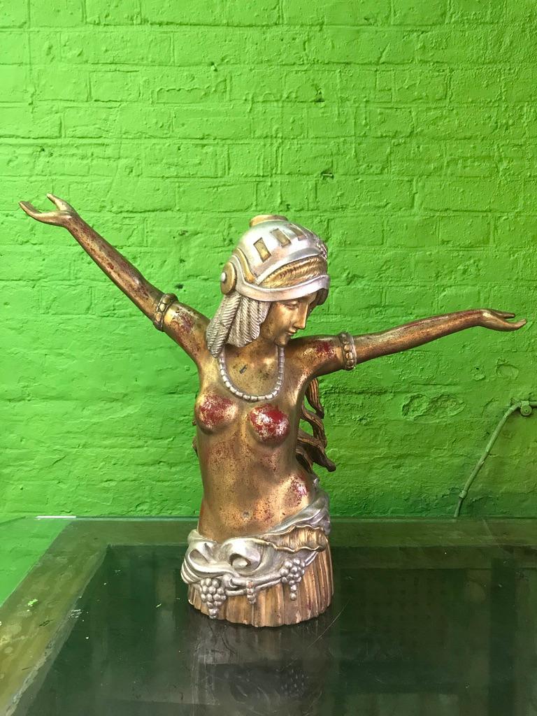 Art Deco carved-wood figure of a lady with her arms stretched out in gold and silver gilt.