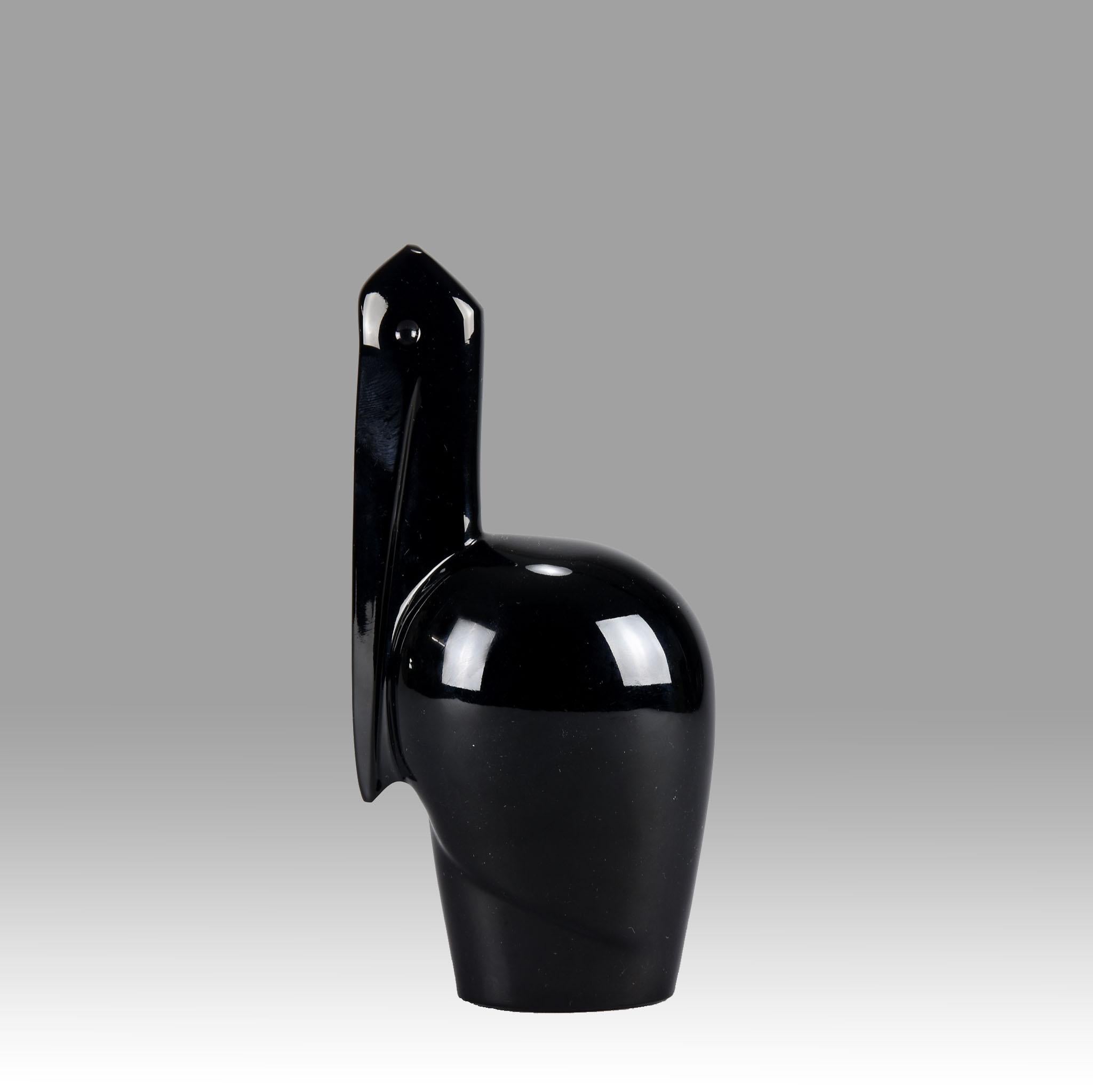 A striking black glass study modelled as an Art Deco stylised pelican with very fine smooth tactile surface, signed Baccarat France.

Additional information
Height: 16 cm
Condition: Excellent with light scratches to base
circa: 1950
Materials: