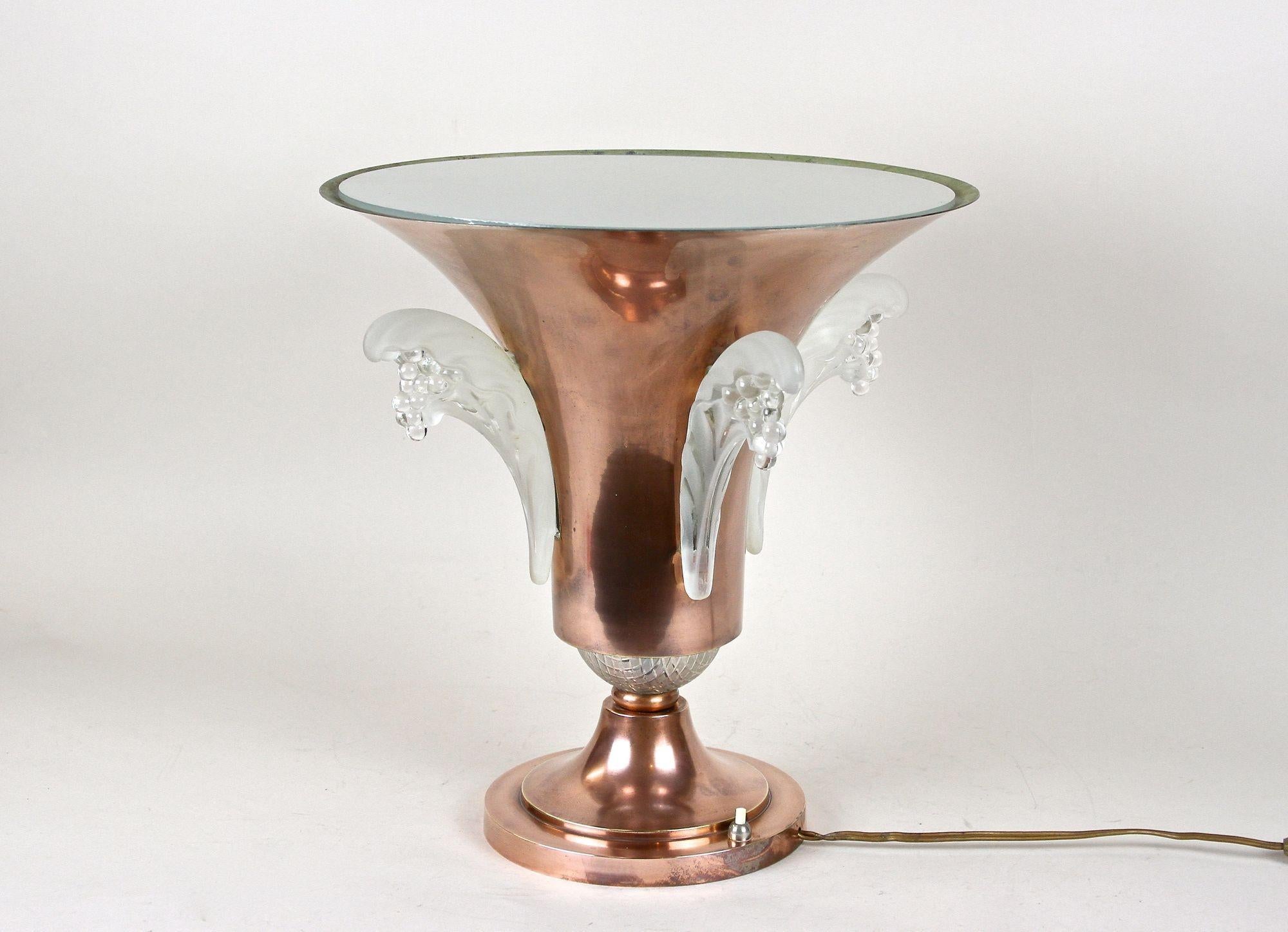 Exclusive Art Deco table lamp from the period around 1920 in France. Artfully designed in form of an urn, this outstanding 20th century French uplighter lamp impresses with its inserted delicate Lalique glass elements, which confers this