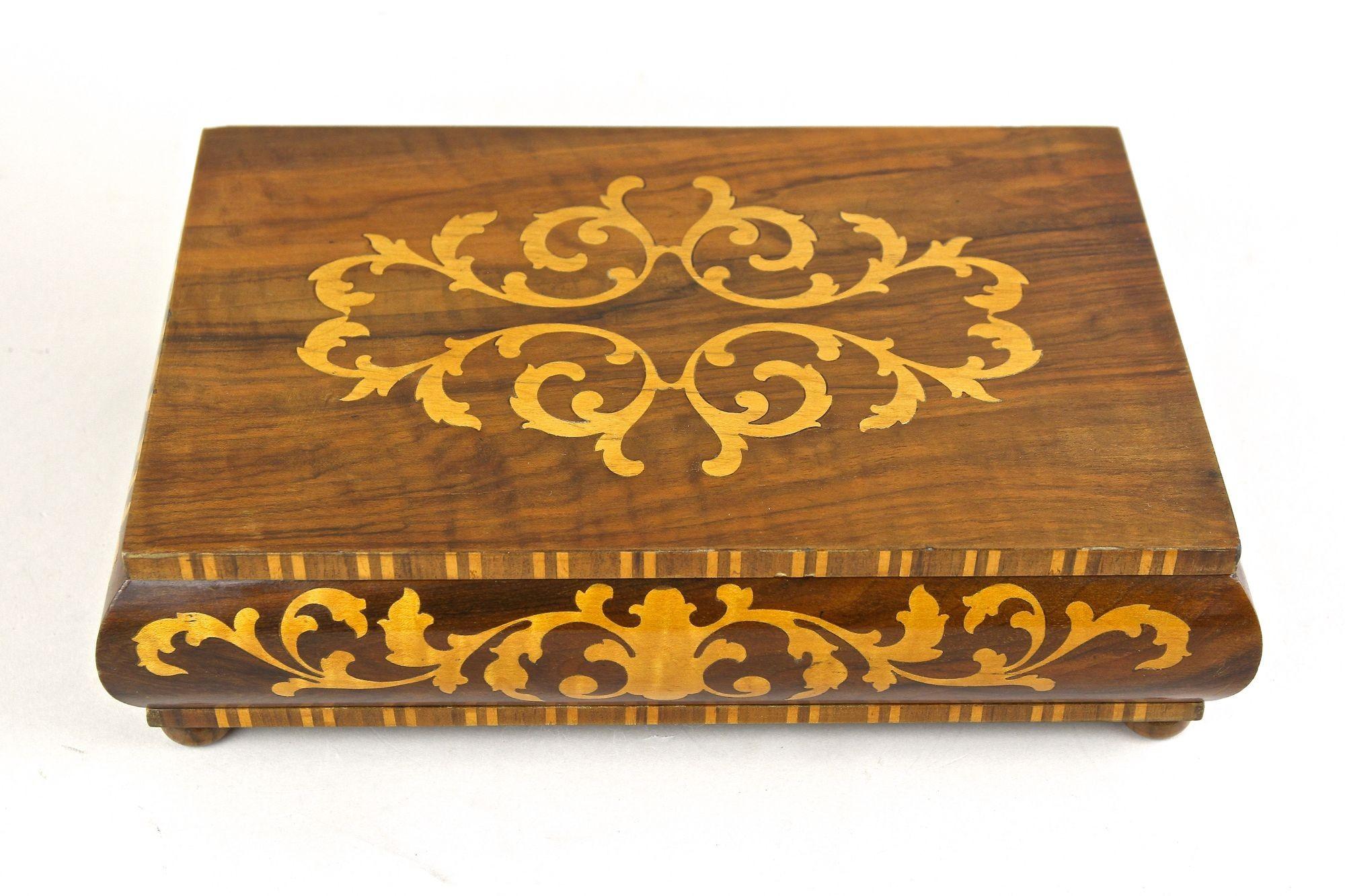 Caja Art Decó artísticamente elaborada con finas incrustaciones procedentes de Austria, de principios de la época, alrededor de 1920. Se ha utilizado magníficamente madera de nogal y nogal, lo que confiere a esta caja bulbosa única un aspecto