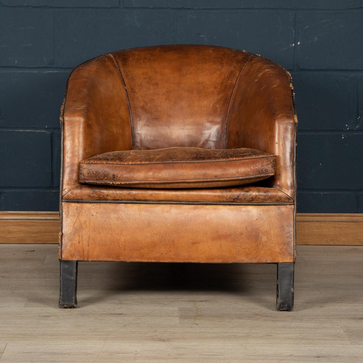 Showing superb patina and colour, this wonderful club chair was hand upholstered sheepskin leather in Holland by the finest craftsmen. With a rich tan colour leather, this particular model could well be a one-off. The chair has been constructed with