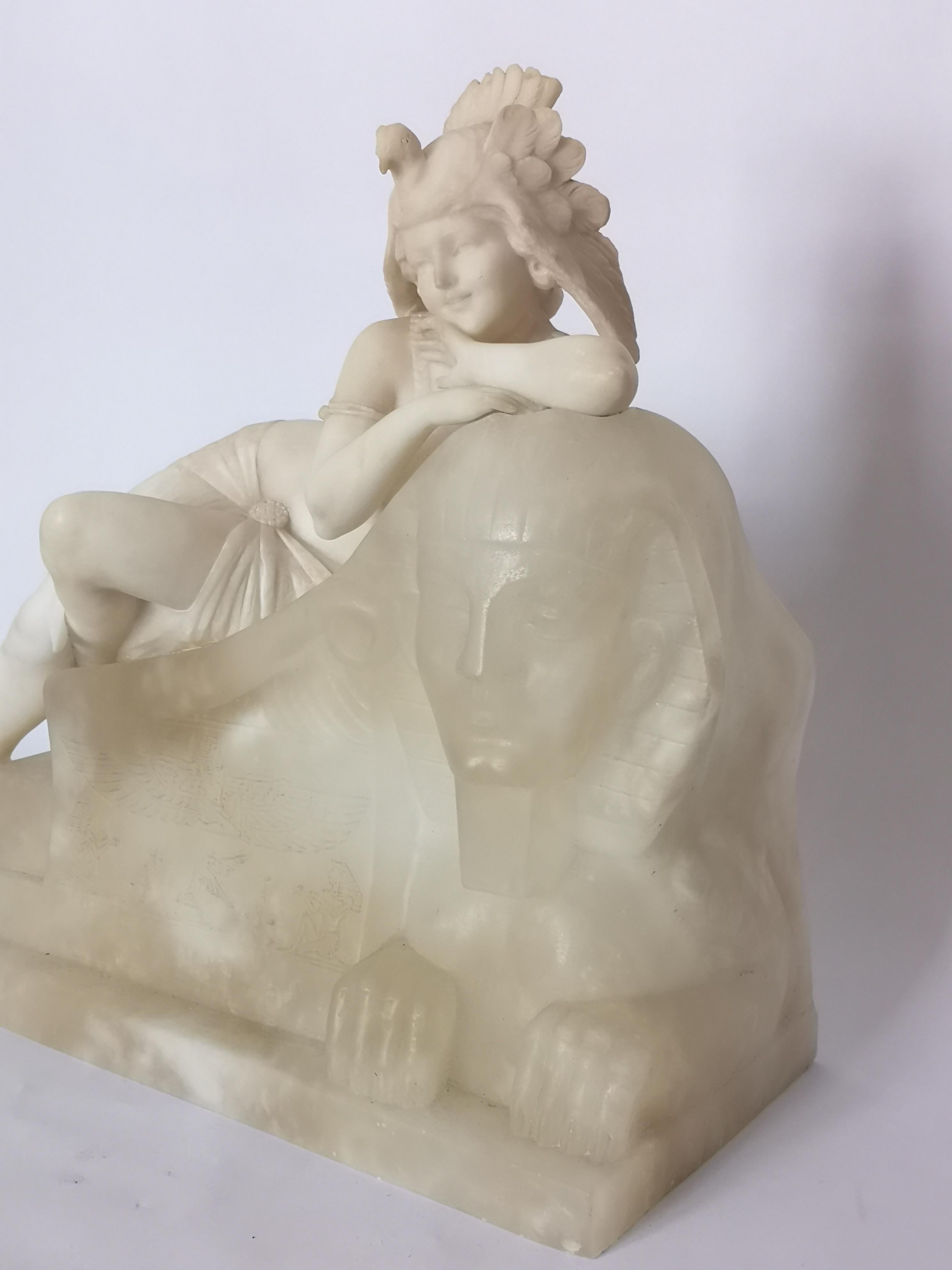 This fantasy sculpture of an art deco lady is fashioning a hat in the form of a bird and resting on a Sphinx. Inside the Sphinx is a light bulb which illuminates the hyroglifics.
Signed 'A Saccard'
French, circa 1930.