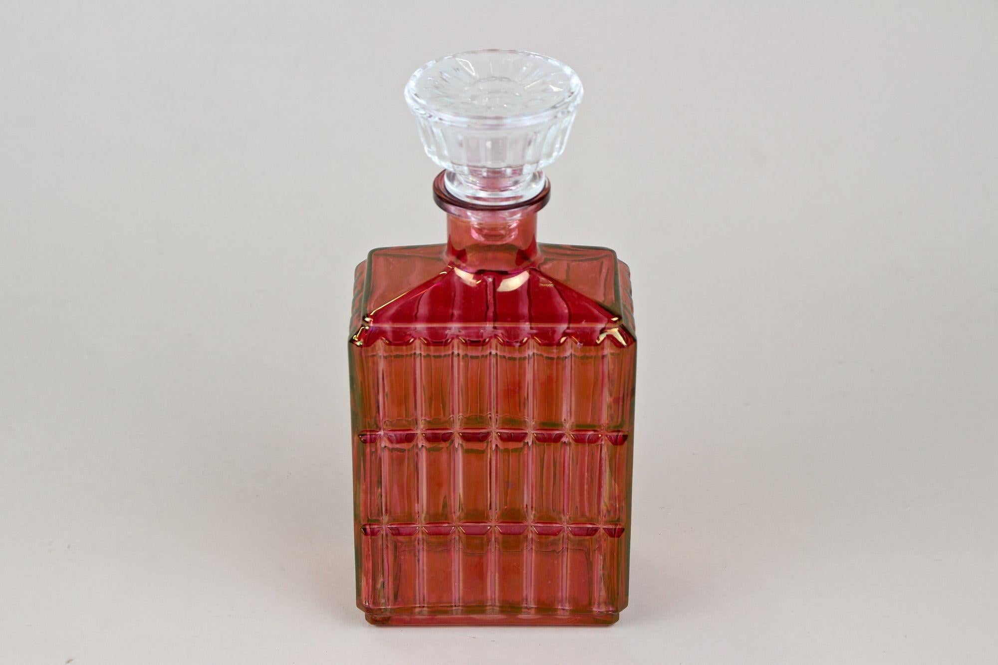 Beautiful 20th century Glass Decanter or Liquor Bottle from the Art Deco period in Austria around 1930. An absolute artfully crafted bottle made of red colored glass. This very decorative piece of Austrian glass art impresses with a timeless, modern