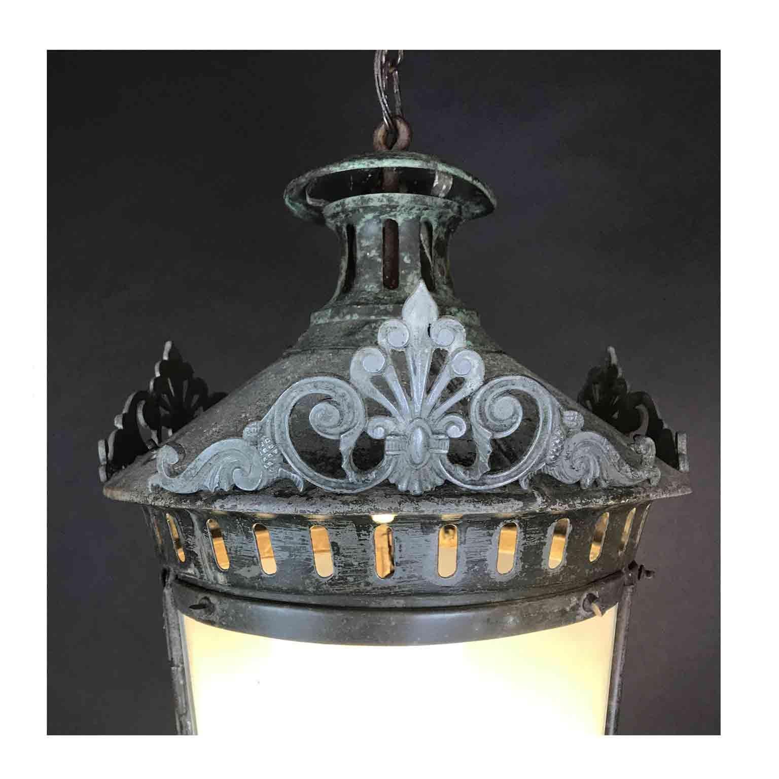 A charming Art Deco hanging hall lantern from Italy, a circular zinc lantern with three original curved frosted glass, one set in the frame of a window.

This antique interior lantern is finely decorated in the upper part by three cast metal