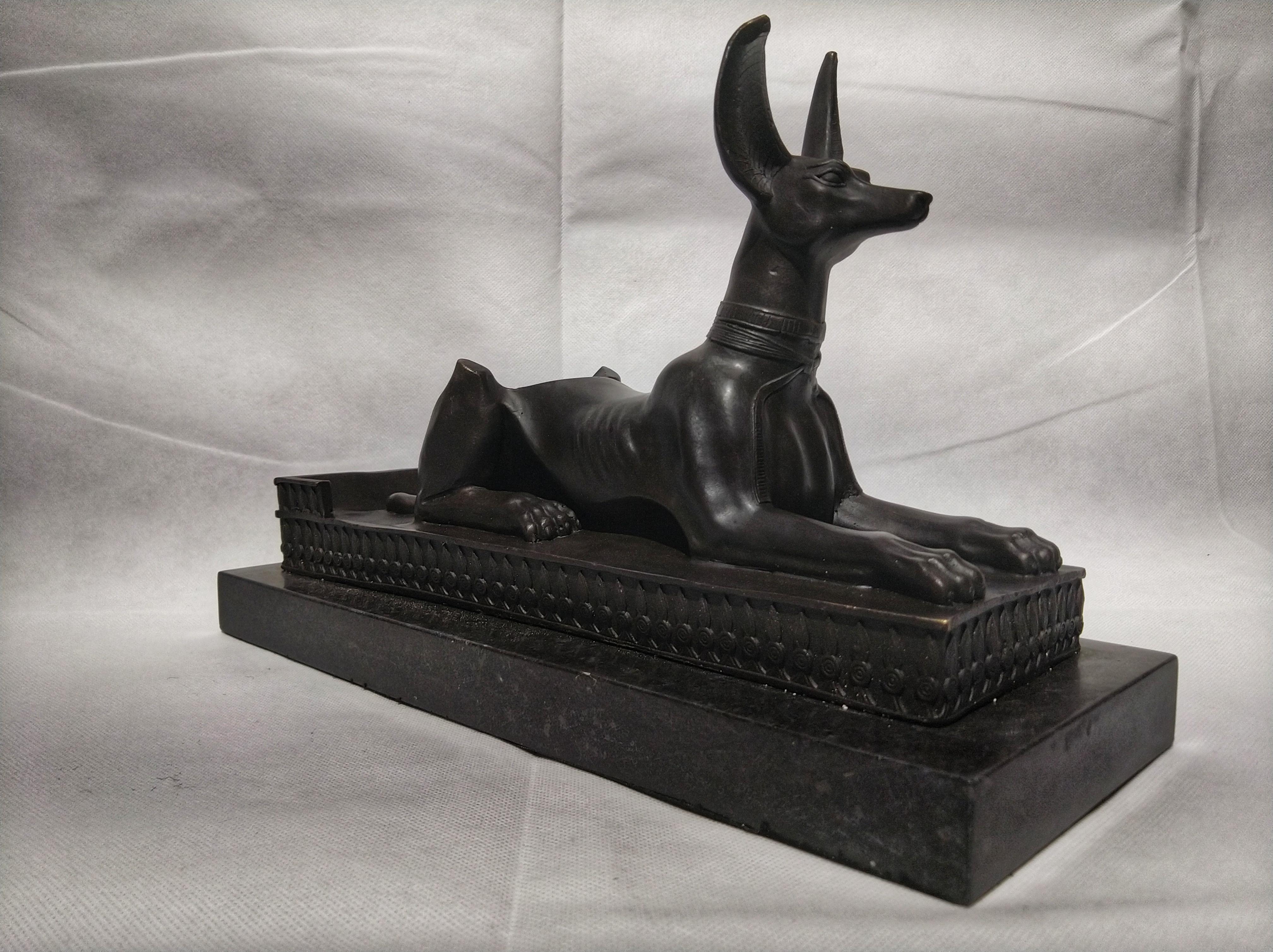Beautiful Art Deco style sculpture bottle holder, depicting Anubis Sphinx (Egyptian God of mummification). And is sitting on a black marble base.

Anubis is the Greek name of a god associated with mummification and the afterlife in ancient Egyptian