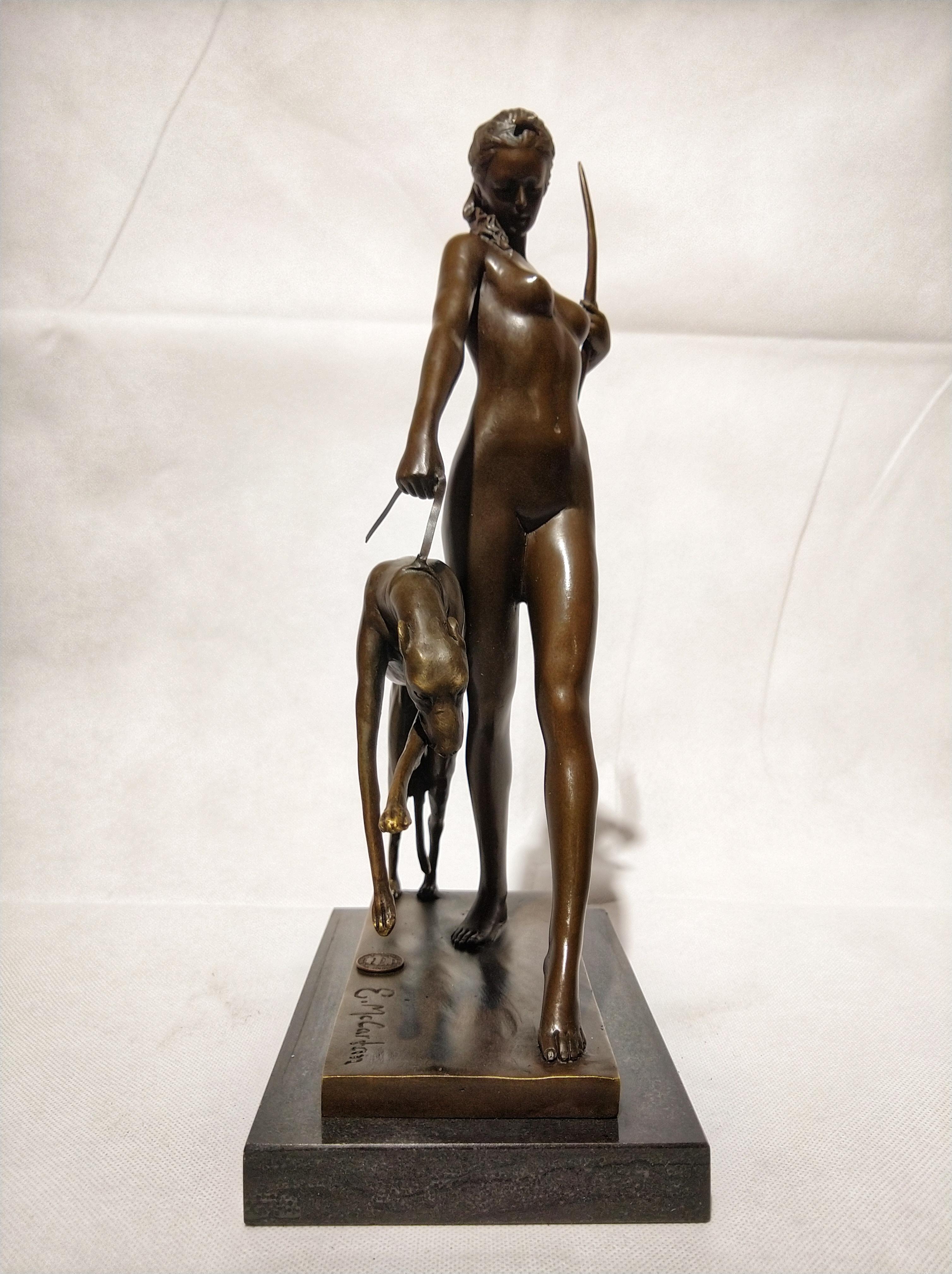 Beautiful Art Deco style sculpture, depicting naked diana, Roman goddess of hunting. In his right hand he holds his greyhound and in his left hand his bow. And is sitting on a black marble base. Signed E. McCartan, with bronze certificate