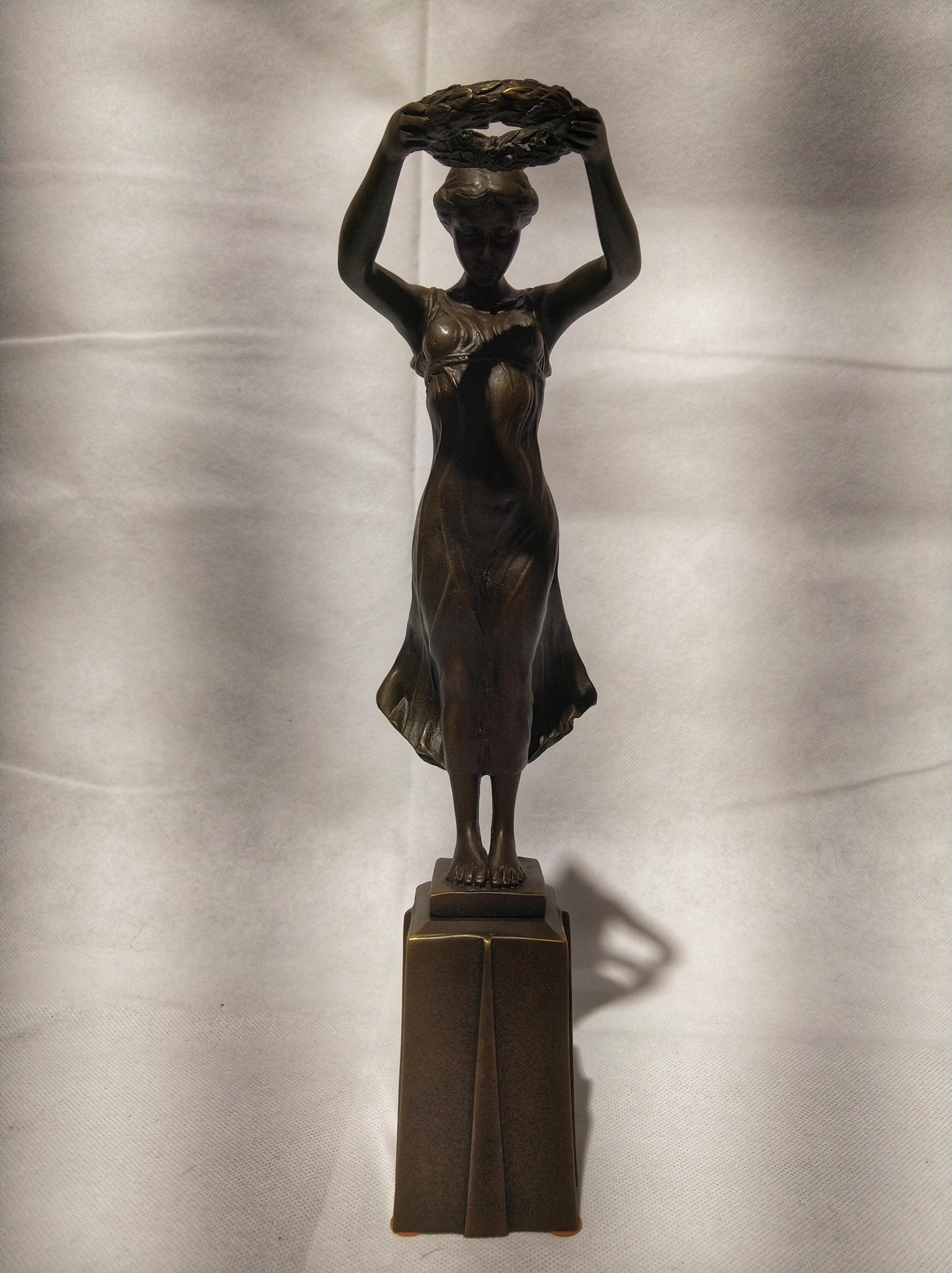Beautiful Art Deco style sculpture, depicting the nimph Daphne with a laurel crown in his hands that it was given as a prize to the winners of the competitions.

Daphne a minor figure in Greek mythology, is a naiad, a variety of female nymph
