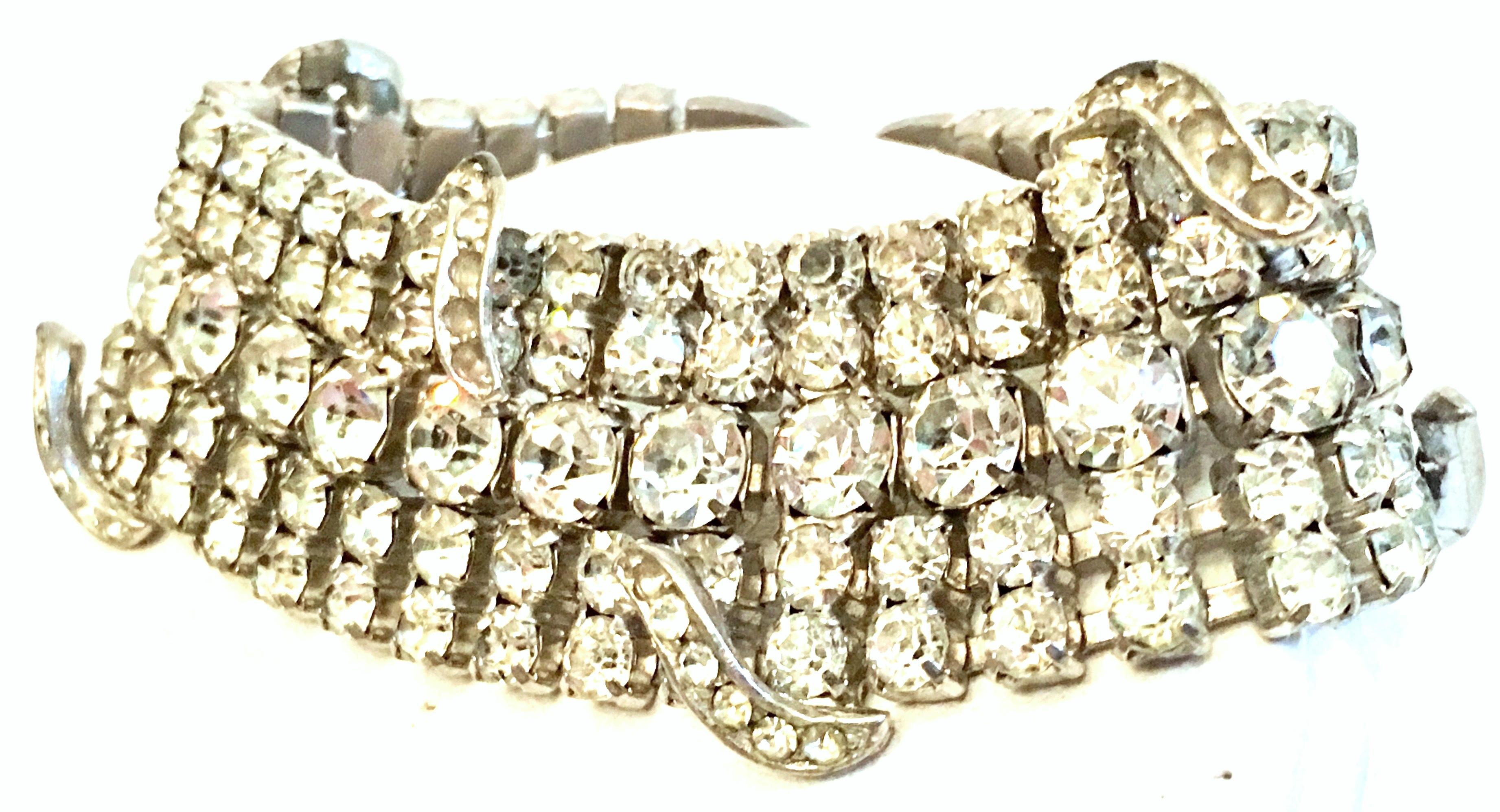 Mid-20th Century Silver & Austrian crystal Art Deco Bracelet. This substantial silver plate prong set bracelet features curved and raised over mount detail with brilliant cut and faceted colorless prong set stones. The clasp is fold over box style