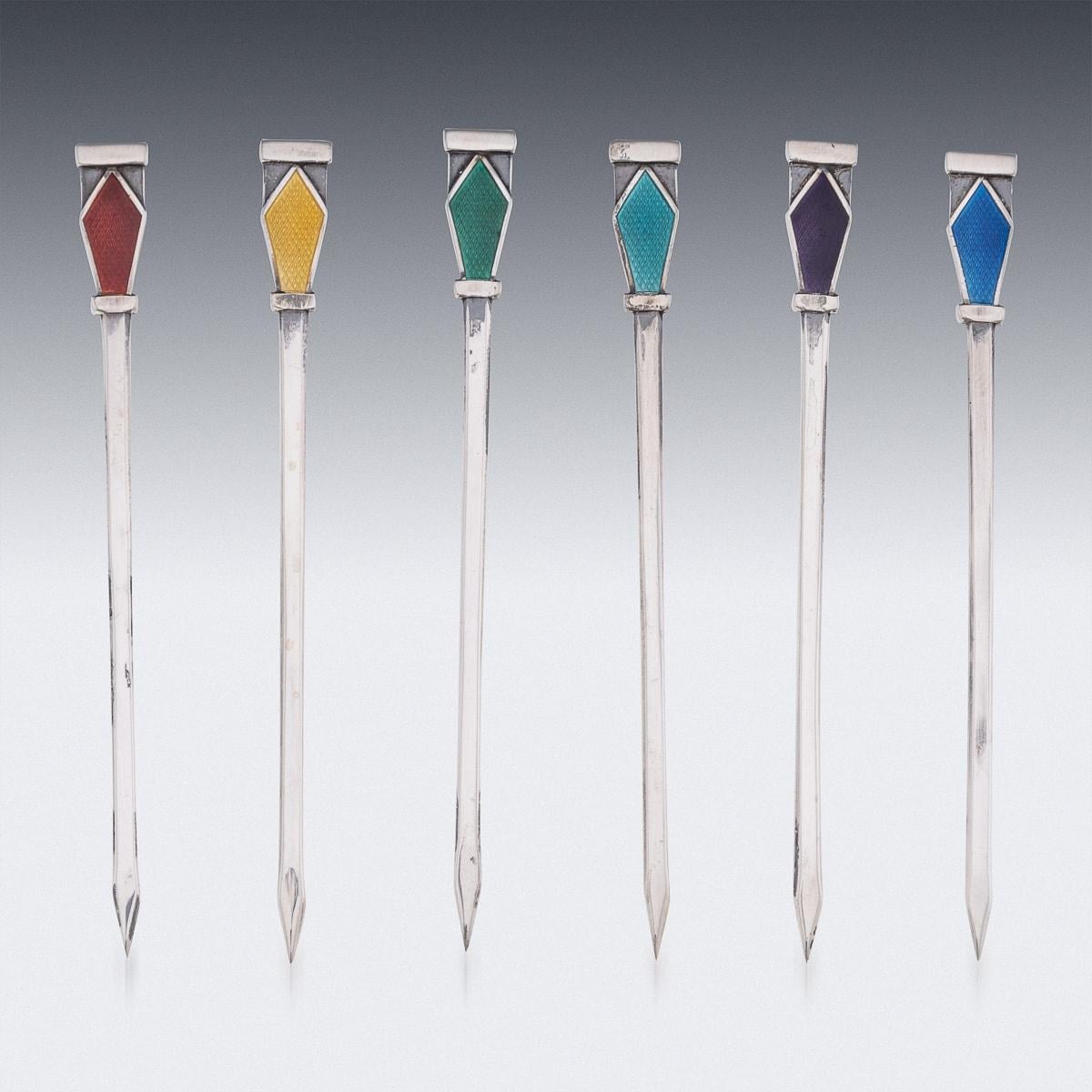 Antique 20th Century British Art Deco solid silver set of six cocktail picks, decorated with multi-coloured guilloche enamels. The set comes in its original leatherette and velvet lined box. Each piece is Hallmarked English silver (925 Standard),