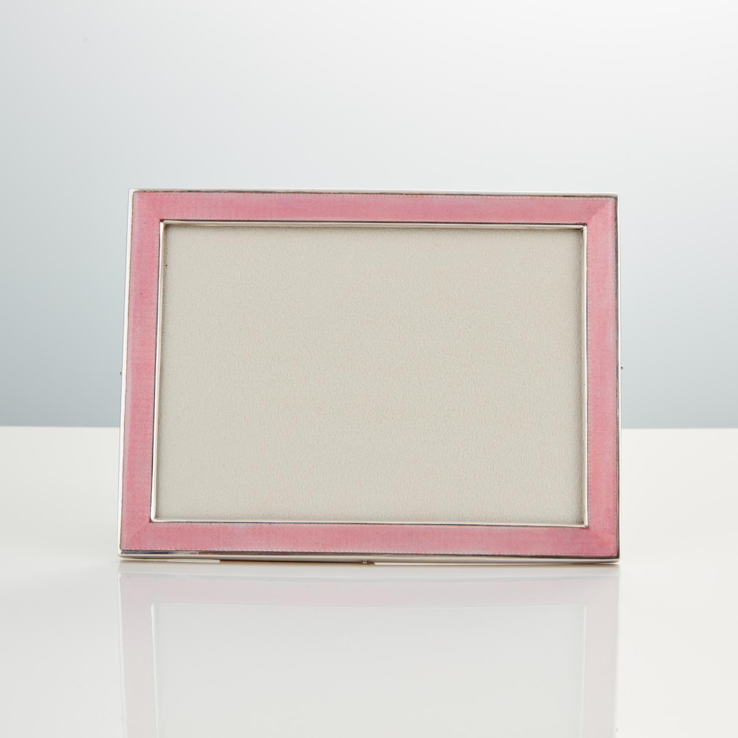 20th century Art Deco sterling silver and Guilloche enamel photo frame date circa 1920

Maker Foster & Bailey Origin USA 

Although being from Art Deco period the colour the rose pink is very much of today.
The gauge of cast silver gives a feel