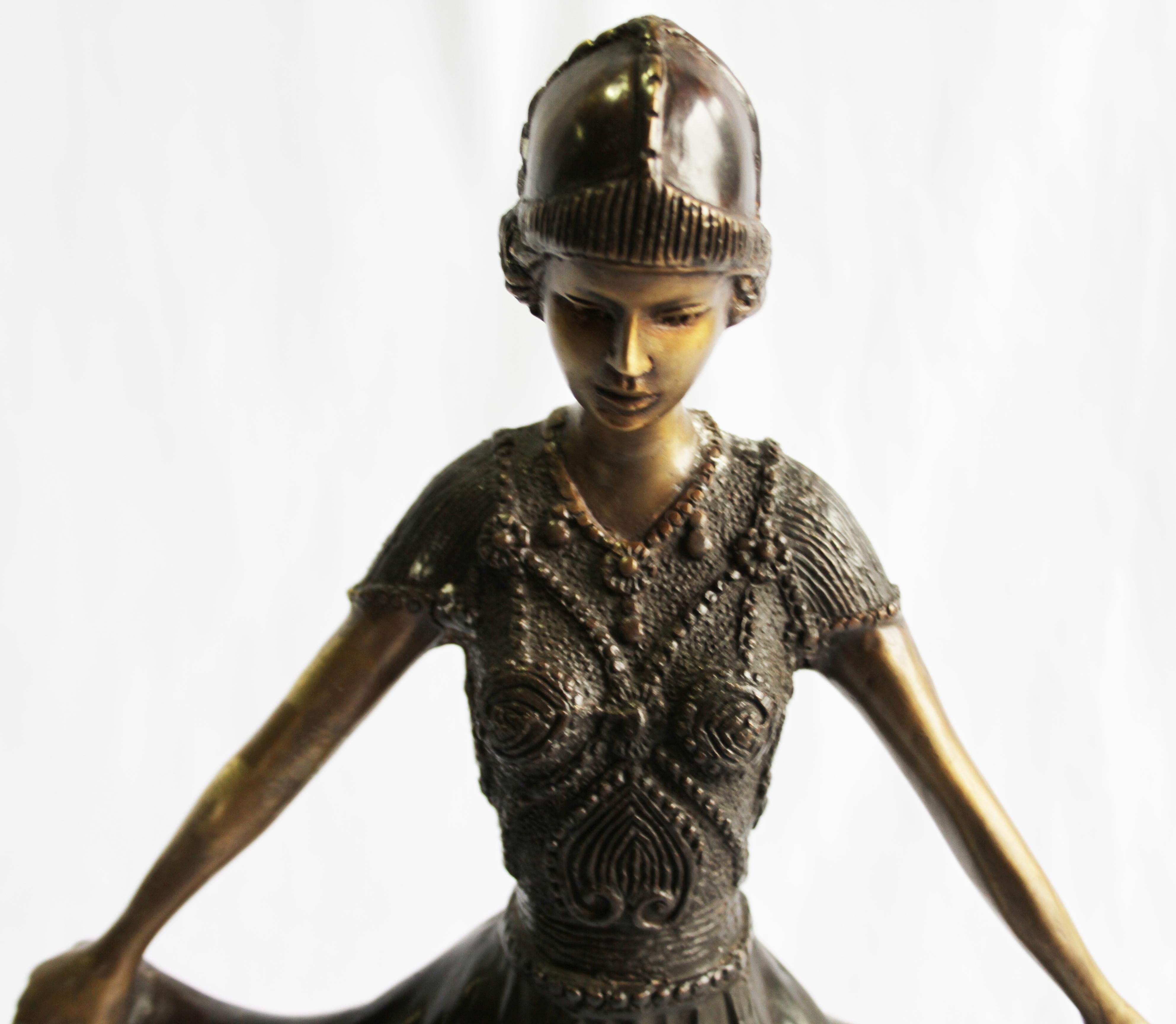 After Demetre Chiparus. An Art Deco style bronze of a dancer, mid-20th century. Dark and gold brown patination. On a circular base.

Demétre Haralamb Chiparus was a Romanian Art Deco era sculptor who lived and worked in Paris, France. He was one of