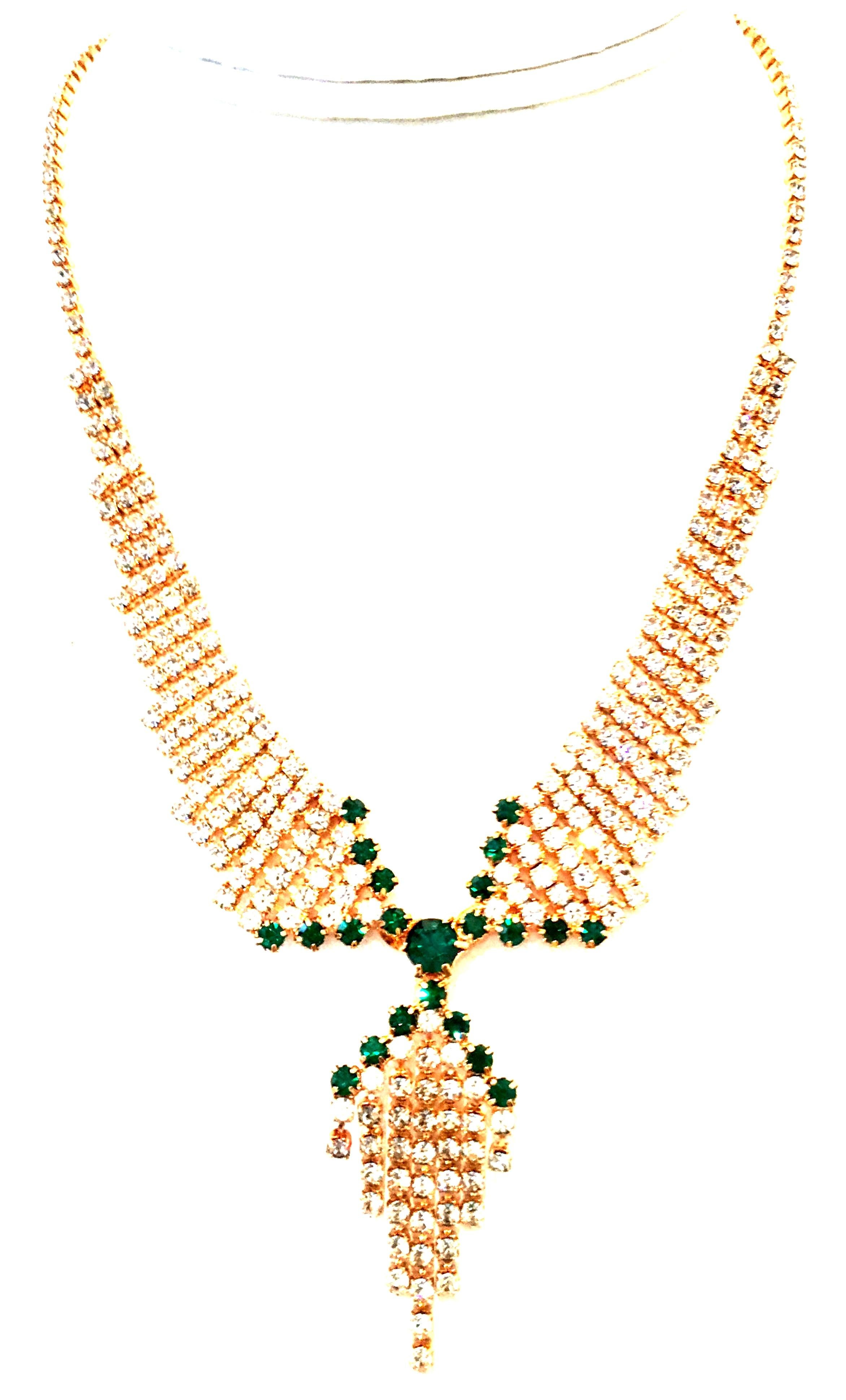 20th Century Gold Plate & Austrian Crystal Tassel Necklace. This finely crafted and festive gold plate with brilliant cut and faceted colorless and emerald green Austrian Crystal fancy set stones feature a “collar” style drop with fringe or tassel