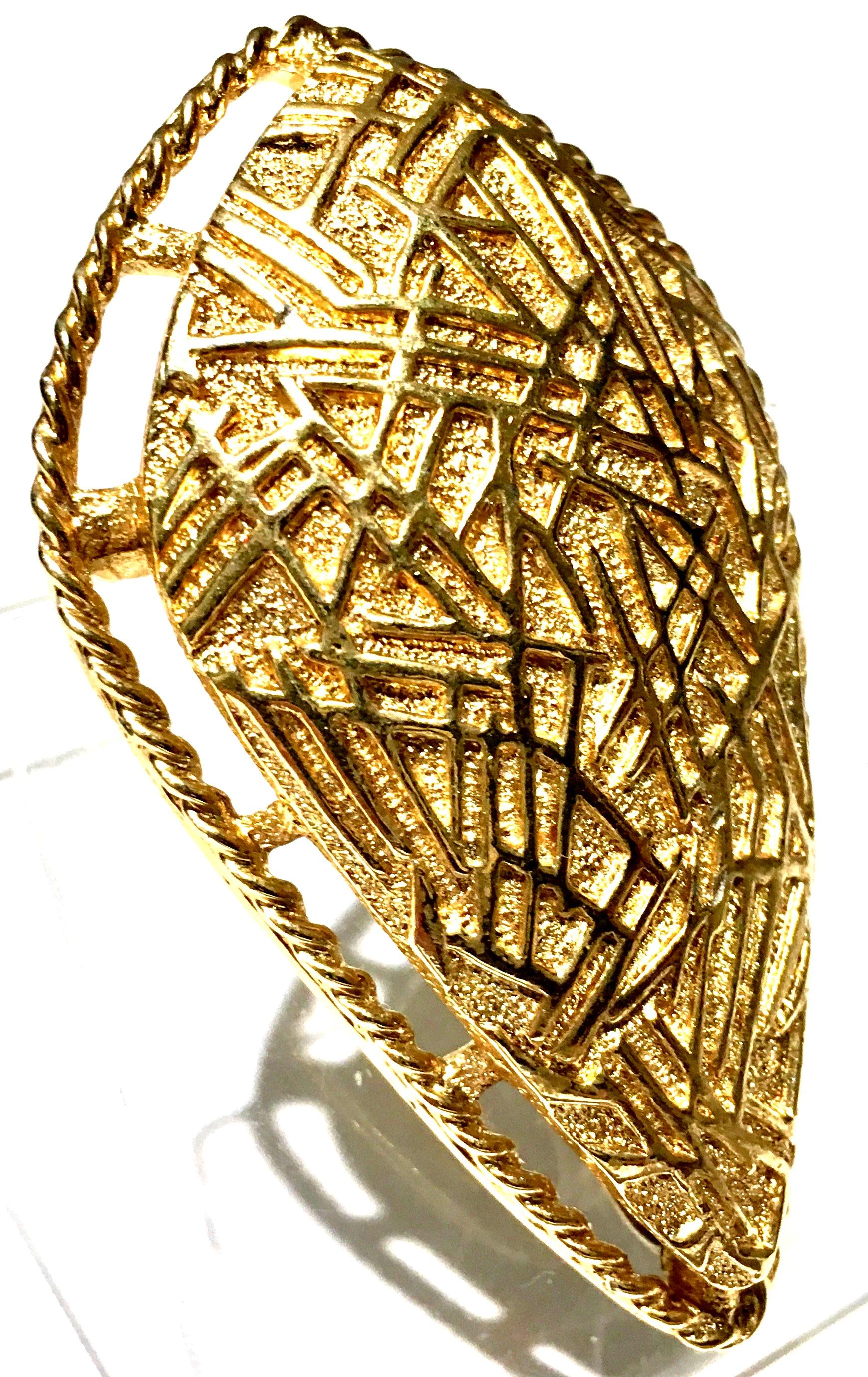 20th Century Art Deco Style Gold Plate Brooch & Necklace Pendant By, Coventry. Signed on the underside, Sarah Cov. This large scale gold Art Deco Style brooch features a dimensional and abstract pattern with a pendant necklace bale on the underside.