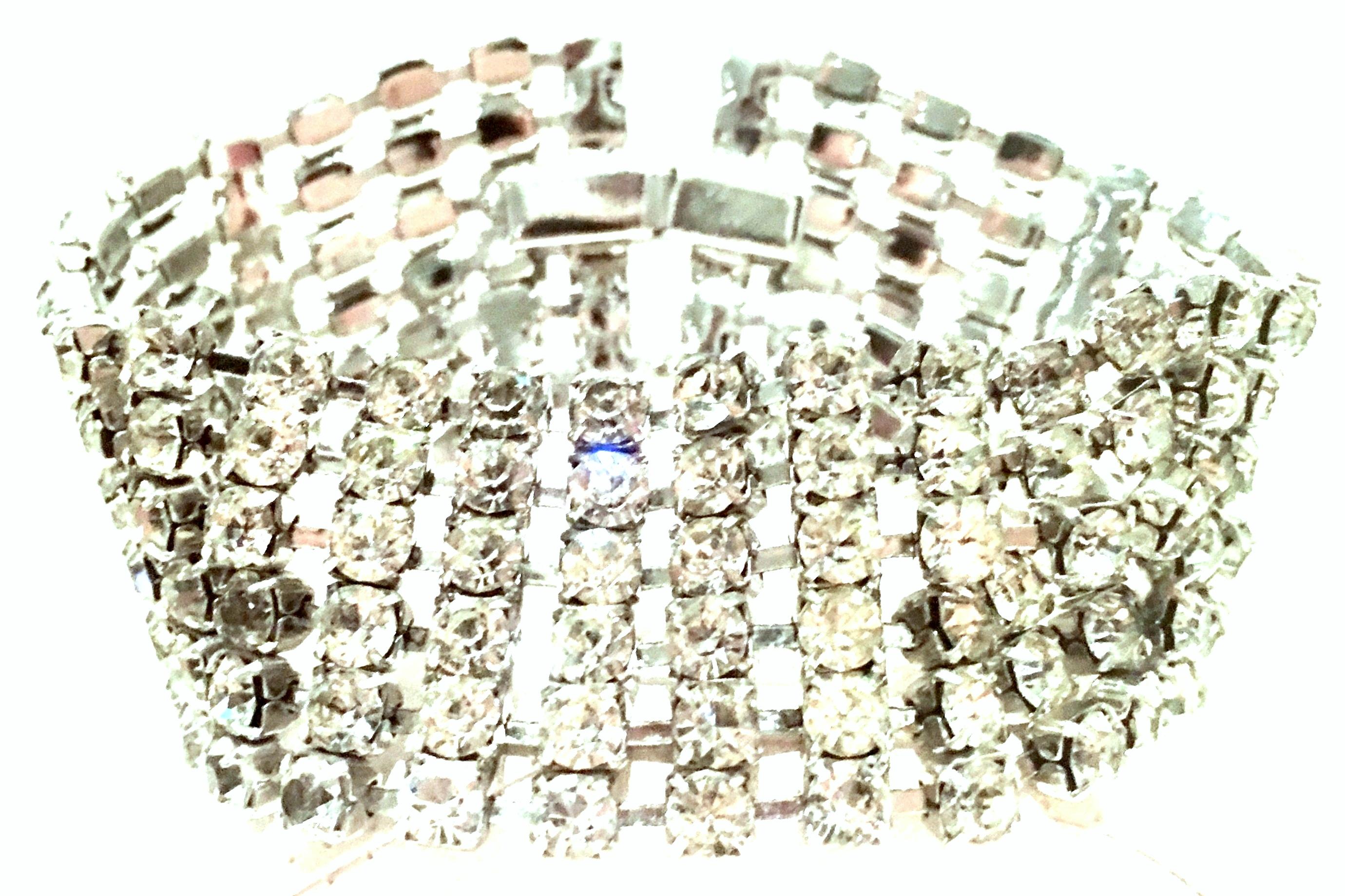 20th Century Art Deco Style Silver & Austrian Crystal Link Bracelet. This finely crafted bracelet features silver rhodium plate base metal with six rows of round prong set brilliant cut and faceted colorless stones. There is a clasp lock and safety