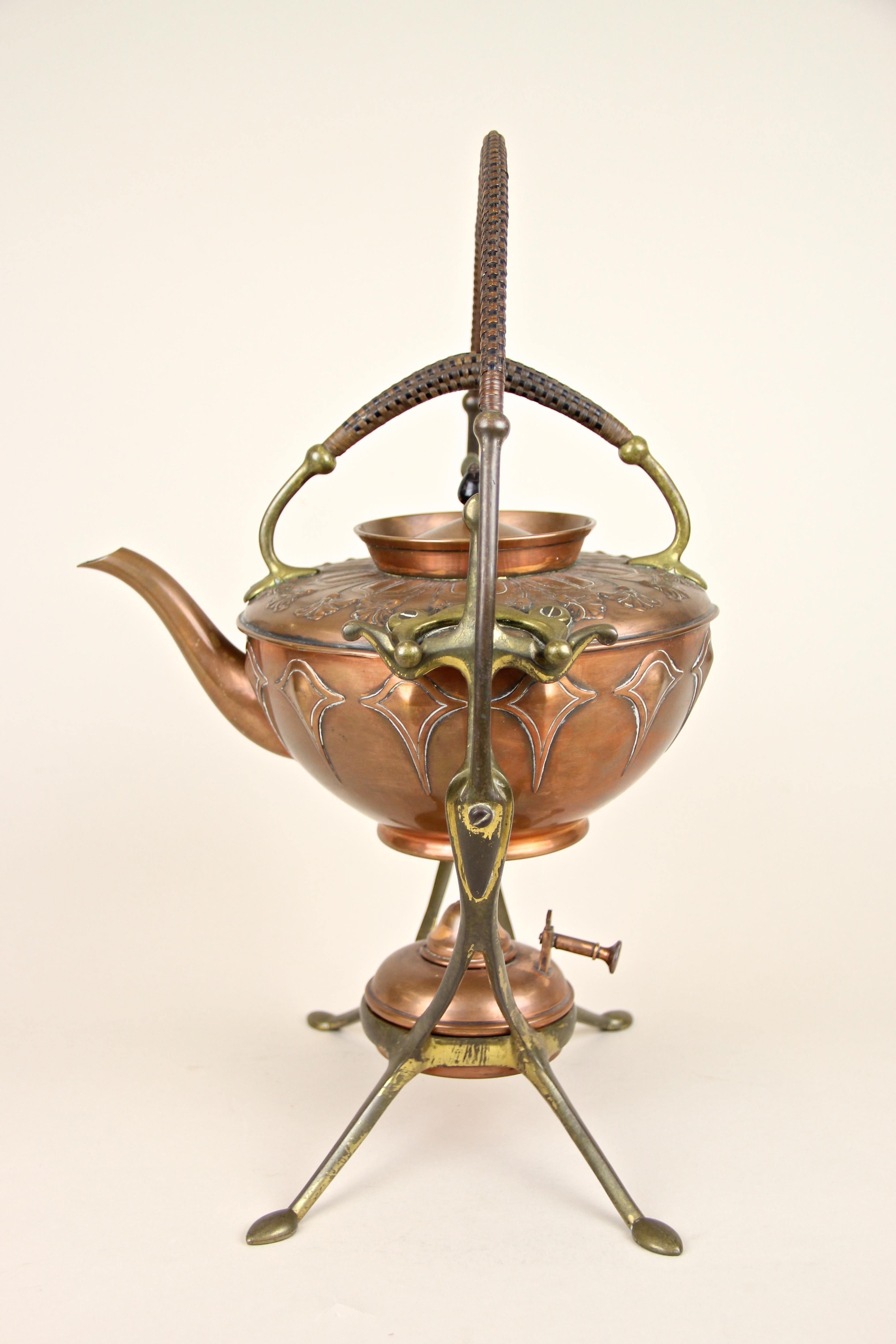 Absolute rare 20th century WMF tea set from the early Art Deco period in Germany, circa 1920. This impressing tea set consists of three very artfully worked pieces: an embossed, copper-plated metal teapot showing fantastic floral ornamentation, a