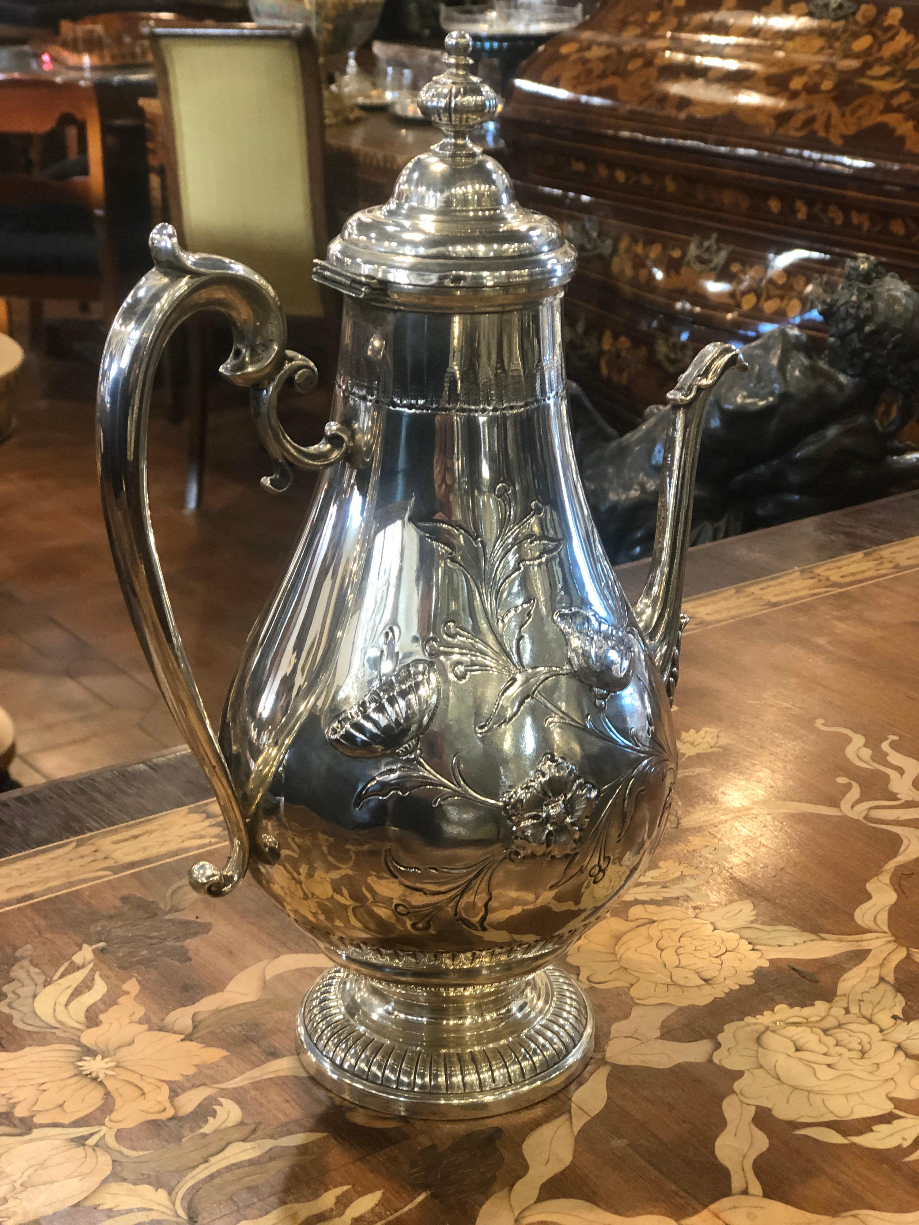 Silver coffee pot, stamped Tiffany & Co., Art Deco era, circa 1940 (this stamp has been in use since 1938). Weight 1150 grams, embossed floral processing. Very elegant in proportions and elegant as all Tiffany objects.