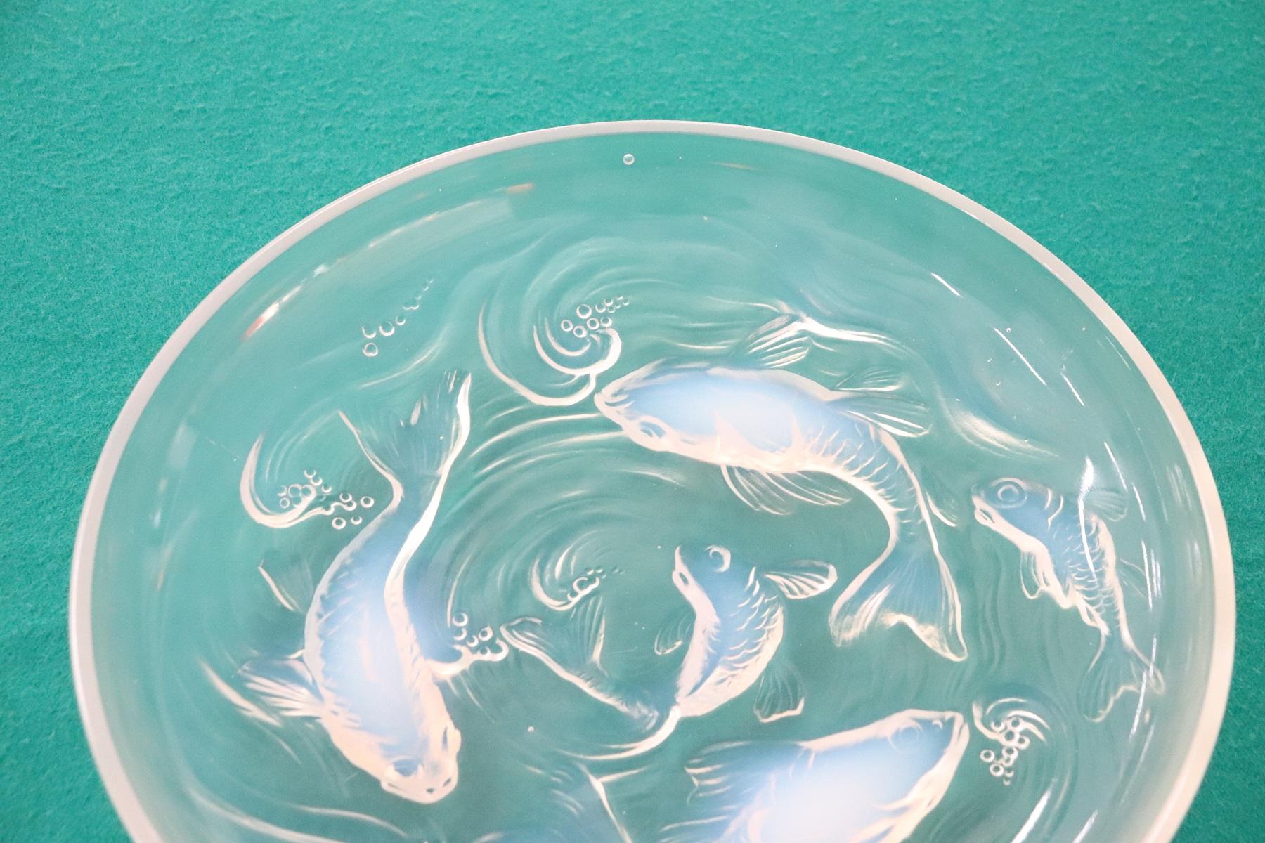Large plate of the fishes series in Transparent glass decorated with fishes in relief iridescent. Verlys, France, circa 1925. Marked in relief on the centre visible against the light.
Collectible glasses.