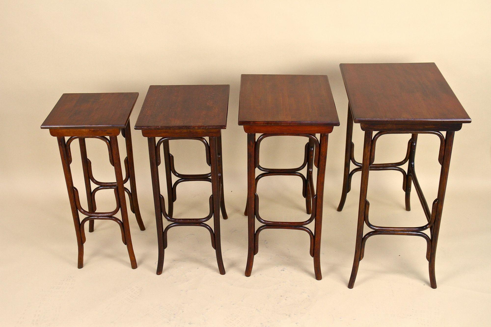 Stunning set of four early Art Nouveau beechwood nesting tables from the period around 1905, made by the world famous manufacturer of bentwood furniture - Thonet Vienna. This beautiful side tables with the model No. 10 were artfully made of fine