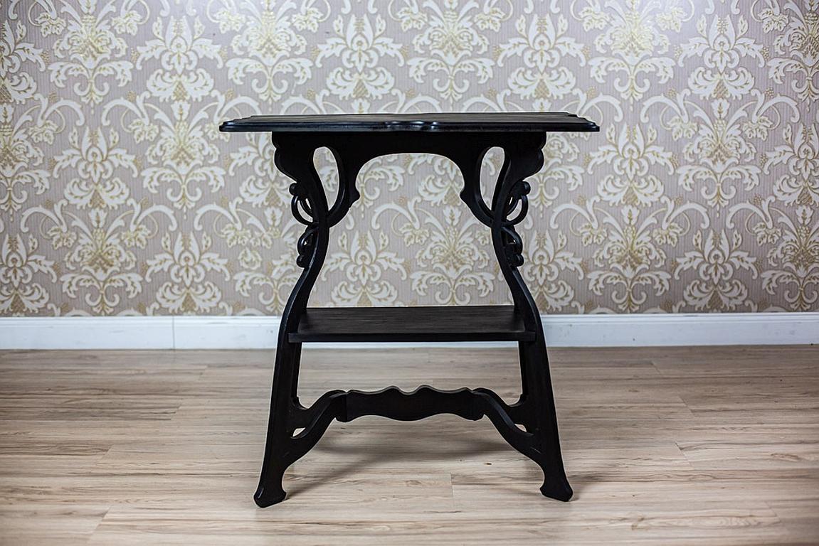 We present you a small Art Nouveau table from the early 20th century.
The rectangular top is supported on wavy legs, which are connected with a Y-shaped stretcher.
At the bottom of the legs, there is an openwork pattern that refers to floral