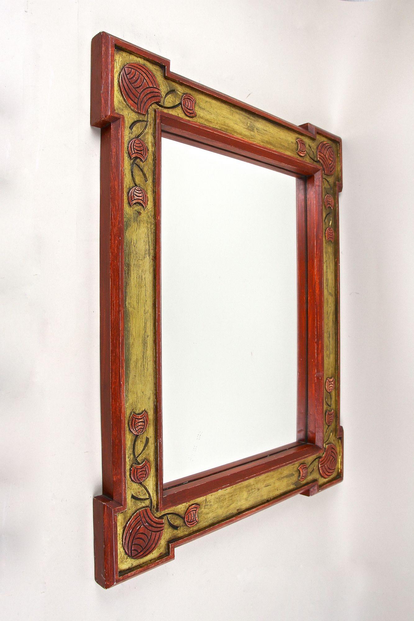 Unusual gilt 20th century Art Nouveau wall mirror from the 1900s in Austria. This amazing looking antique wall mirror with a rustic charme has been hand carved out of softwood around 1900 and impresses with lovely floral-themed carvings building