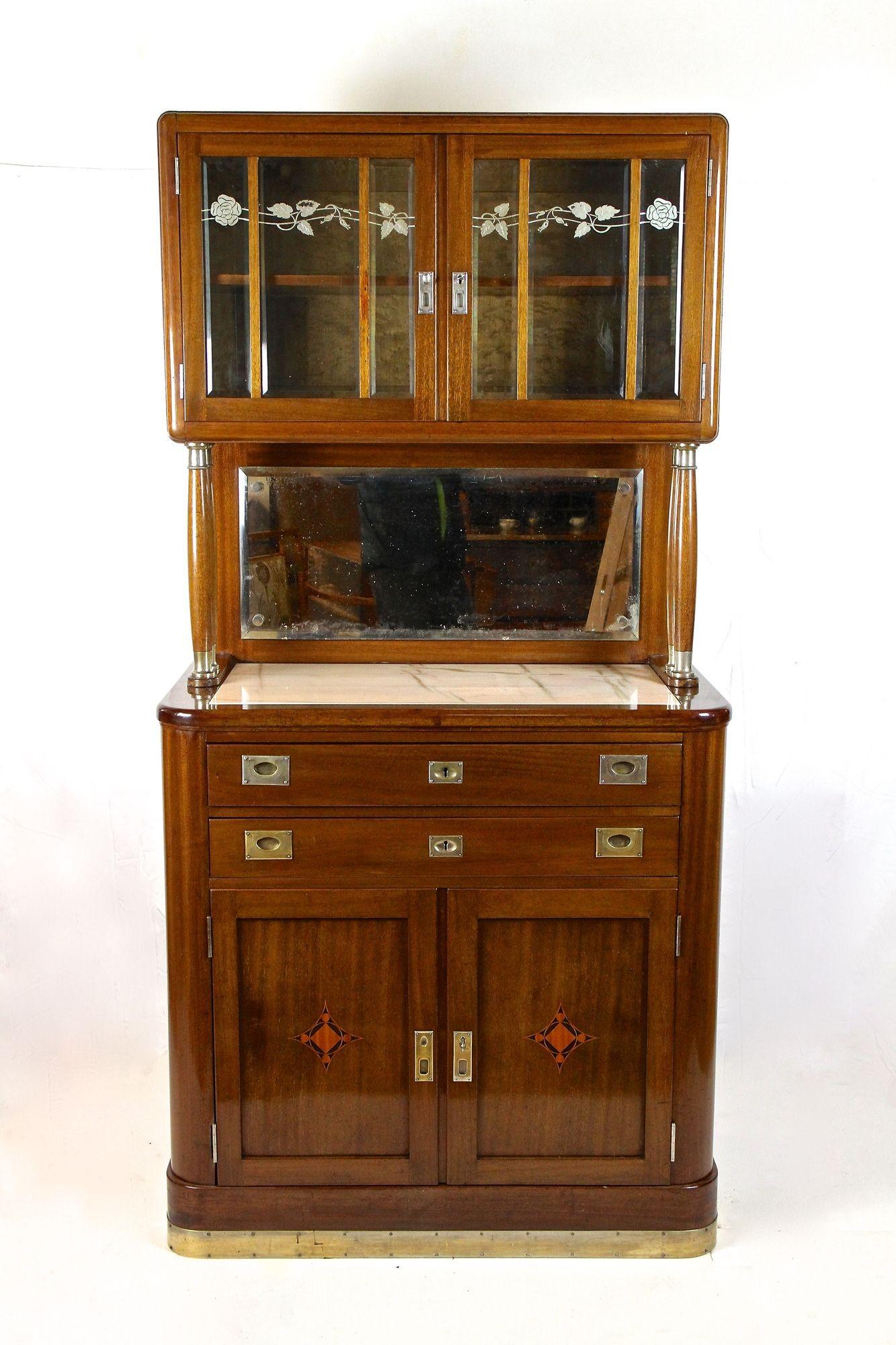 Beautiful early 20th century Art Nouveau buffet/ cabinet out of Austria made by the renowed company of Viennesse cabinetmaker Heinrich Bäck around 1910. The lower part provides two doors, both adorned by a fantastic looking inlayed patterns as well