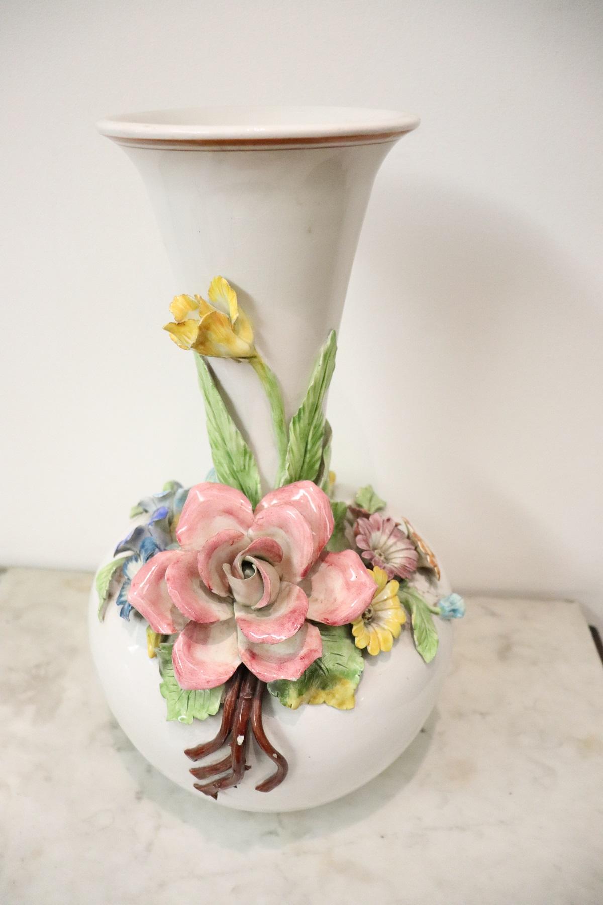 Beautiful ceramic vase characterized by an elaborate decoration. Hand painted with high decoration quality. The white vase is characterized by a bunch of large raised flowers painted by hand with very cheerful spring colors. Italian production of