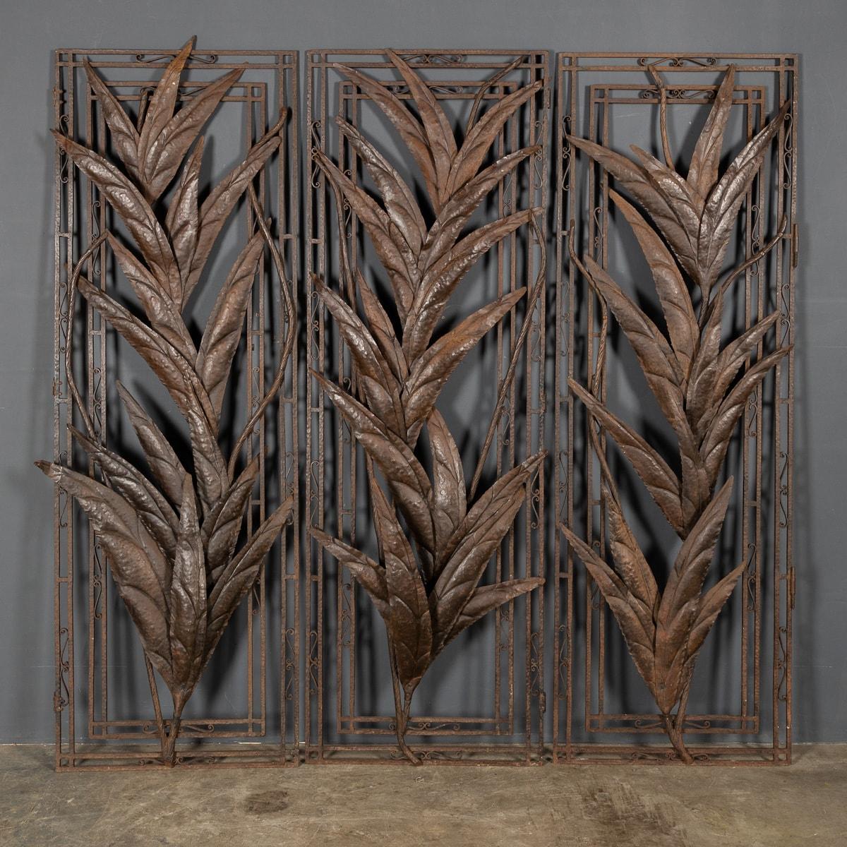 Striking set of three wrought iron panels with a bronze patina from the gates of a French Chateau. These panels applied with elongated leaves and flowers in true arts and crafts style, c.1920.

CONDITION
In Good Condition - no damage.

SIZE
Height: