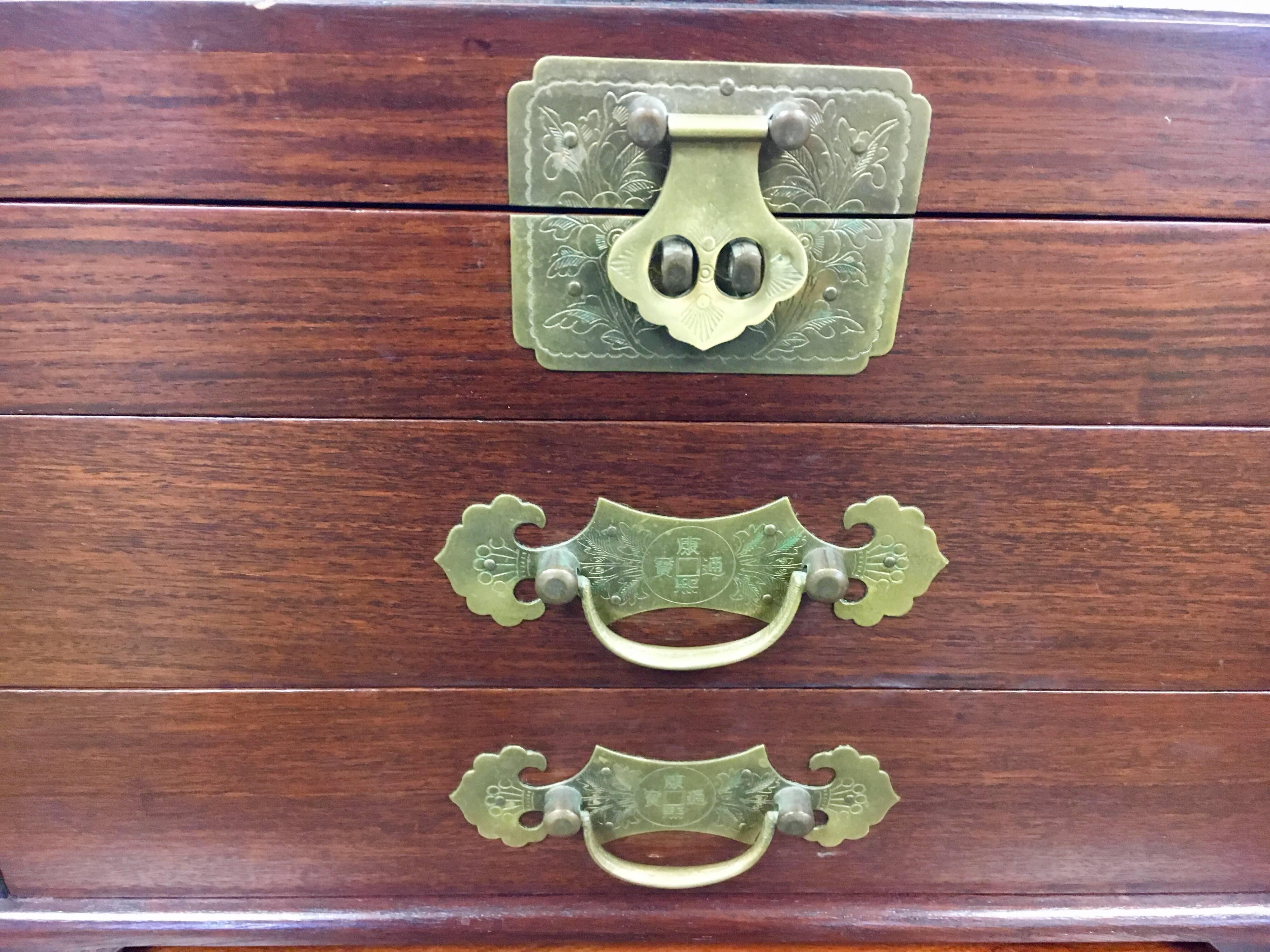Early to mid-20th century Asian wood and iron mounted jewelry box with handles on left and right sides. Features elegant red silk fabric inside for your luxury jewelry.
