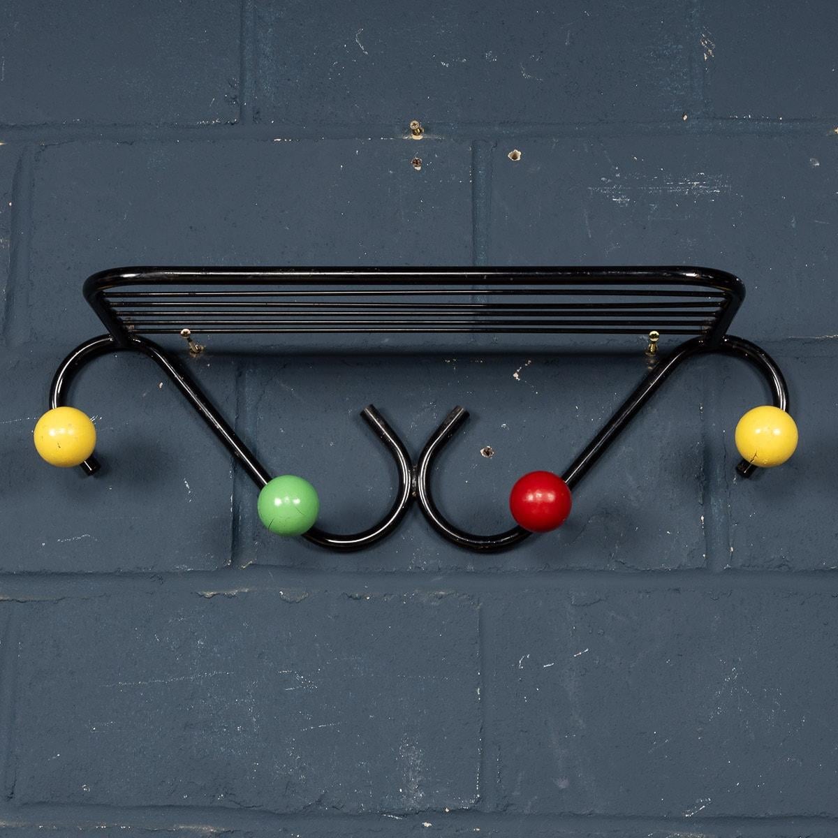The stand created to carry hats and coats, with the typical solid multicoloured wood balls to the ends. The wood balls still bear the original paintwork and although there are obvious signs of wear and tear consistent with normal domestic use, it