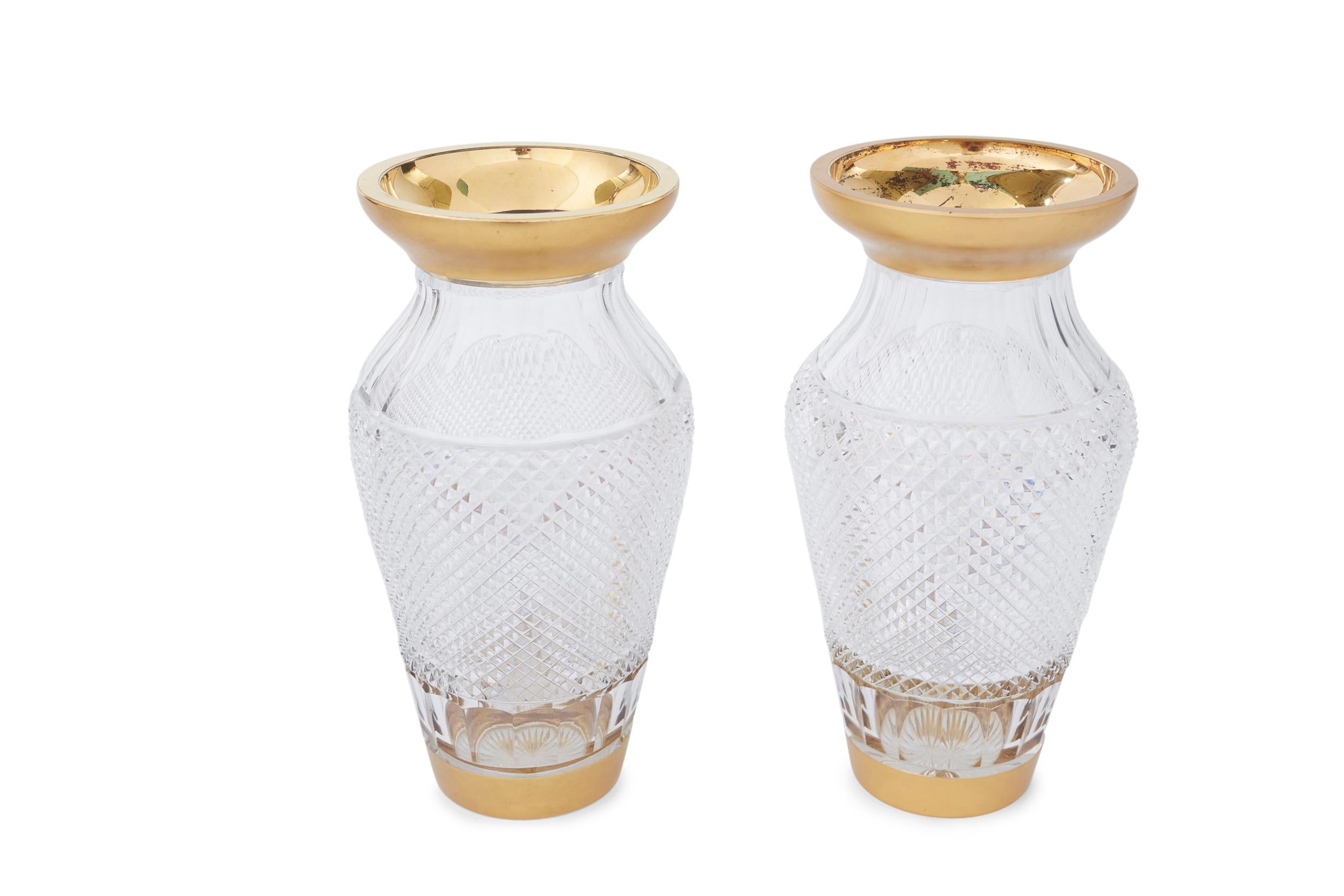 20th century pair cut crystal with gold trimmed top & base details Austrian decorative piece / vase . Each vase is in good condition . Minor wear consistent with age / use . Each one stands about 12 inches tall X 6 inches diameter.