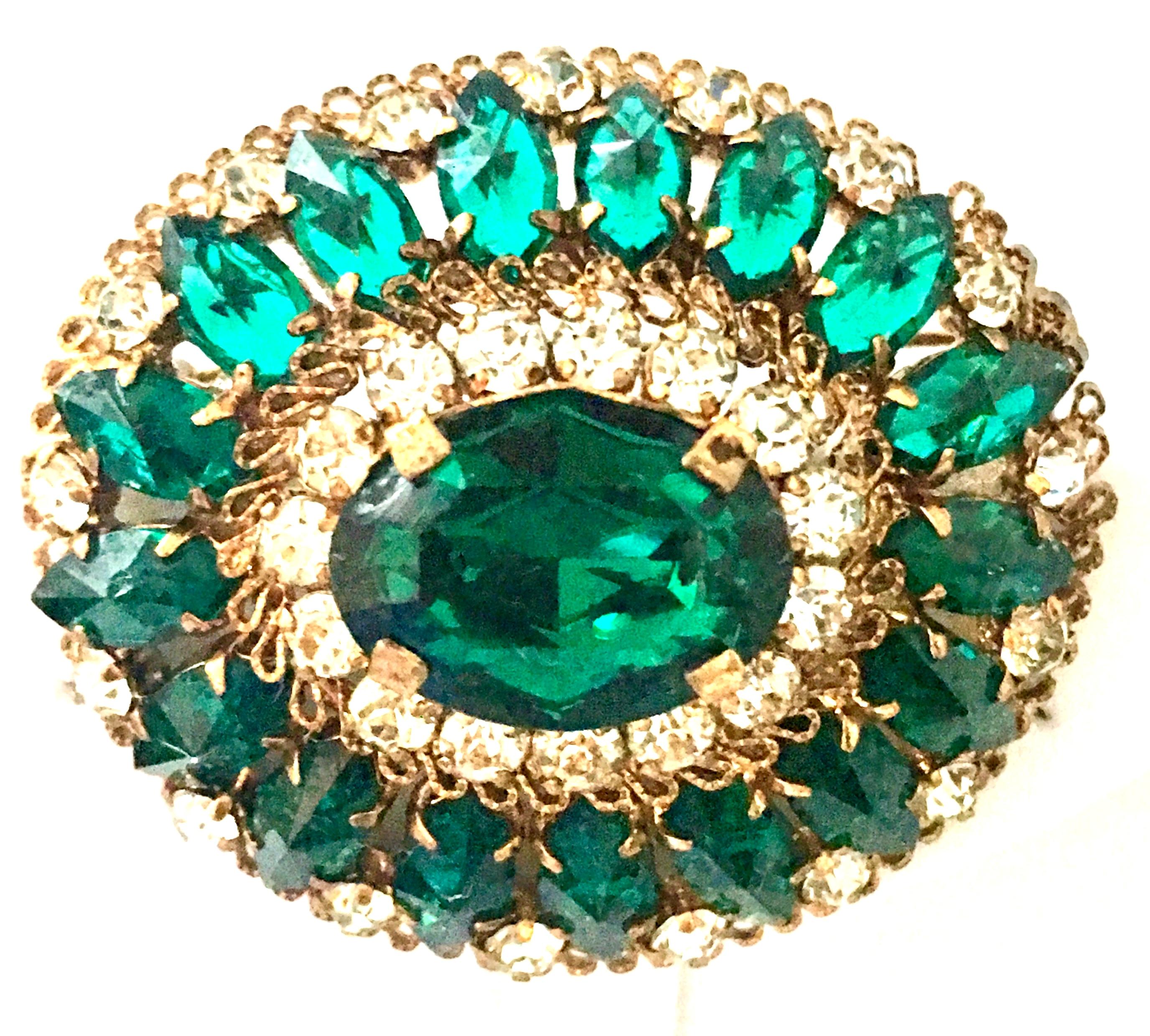 20th Century Gold Plate And Austrian Crystal Oval Dome Brooch-Signed. This fantastic piece is executed with gold plate prong set brilliant cut and faceted emerald green and crystal clear Austrian crystal stones. Features the finest quality in