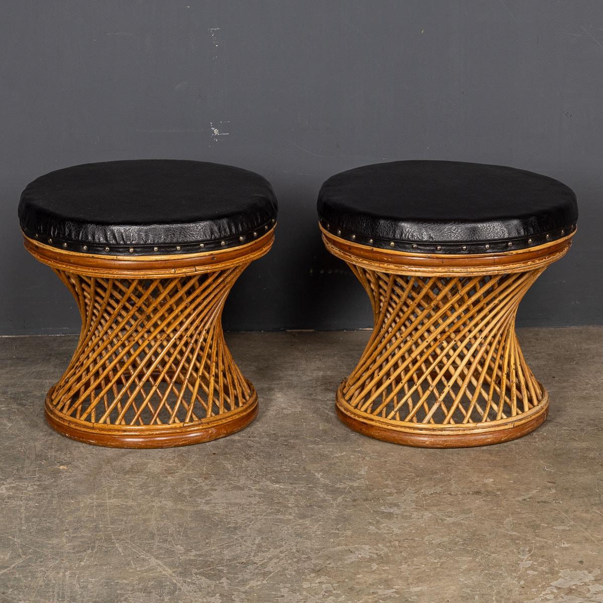 Two charming stools from the mid-20th Century, skilfully crafted from bamboo and adorned with leatherette, boast a captivating design featuring an inter-weaving hourglass-shaped body and a seat cover lined with supple leatherette. These compact low