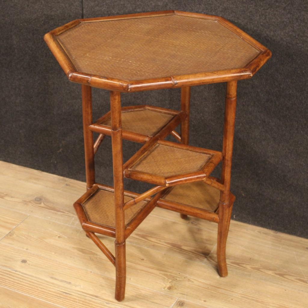 Spanish design side table from the 1970s-1980s. Furniture with structure in bamboo and woven wood of particular line and construction. Side table of excellent proportion equipped with a useful support top and four small shelves in the lower part