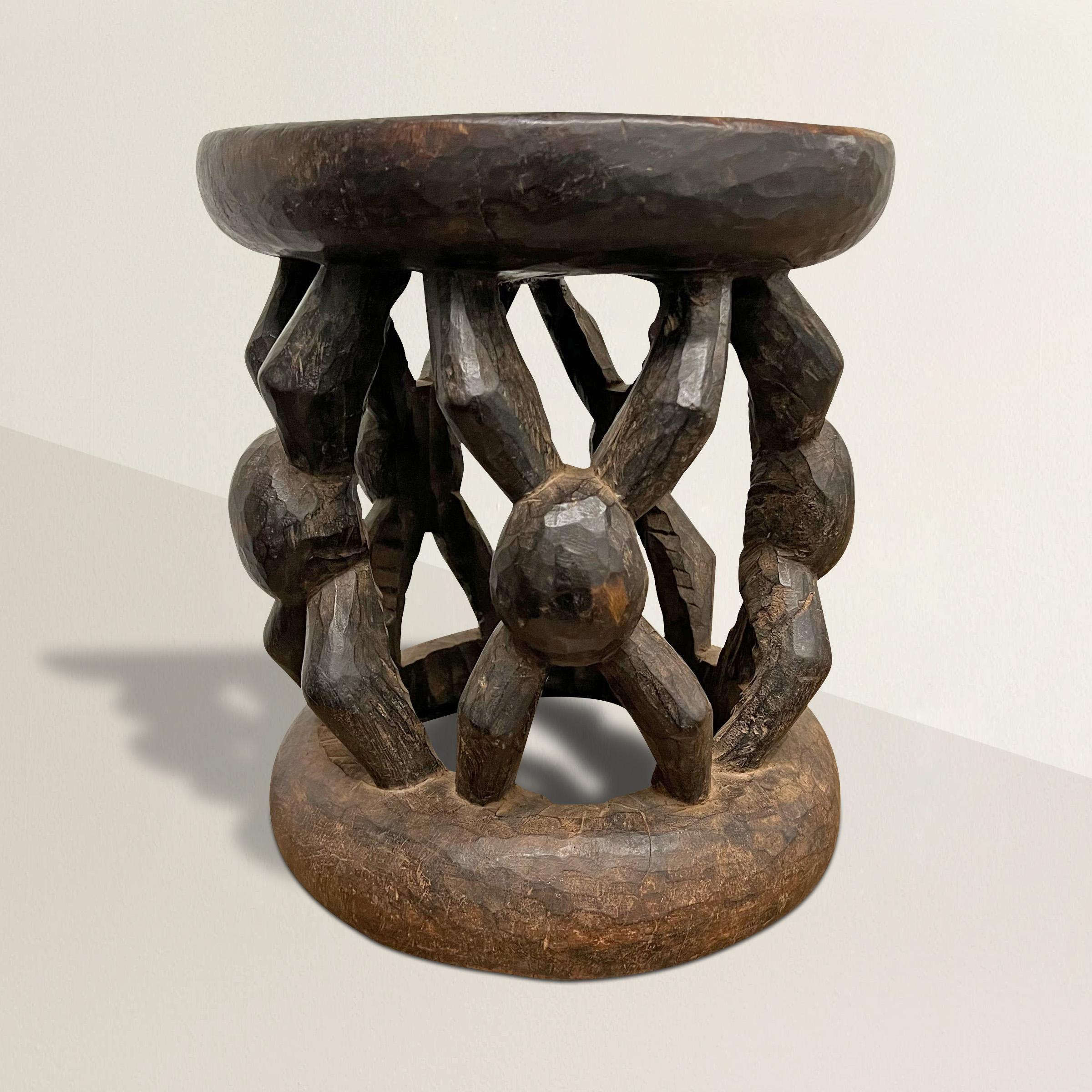 A bold and lively early 20th century Bamileke stool hand-carved of one piece of wood with a wonderful pattern depicting figures with outstretched arms and legs, and with the most beautiful patina that only time can bestow. The stool can also double