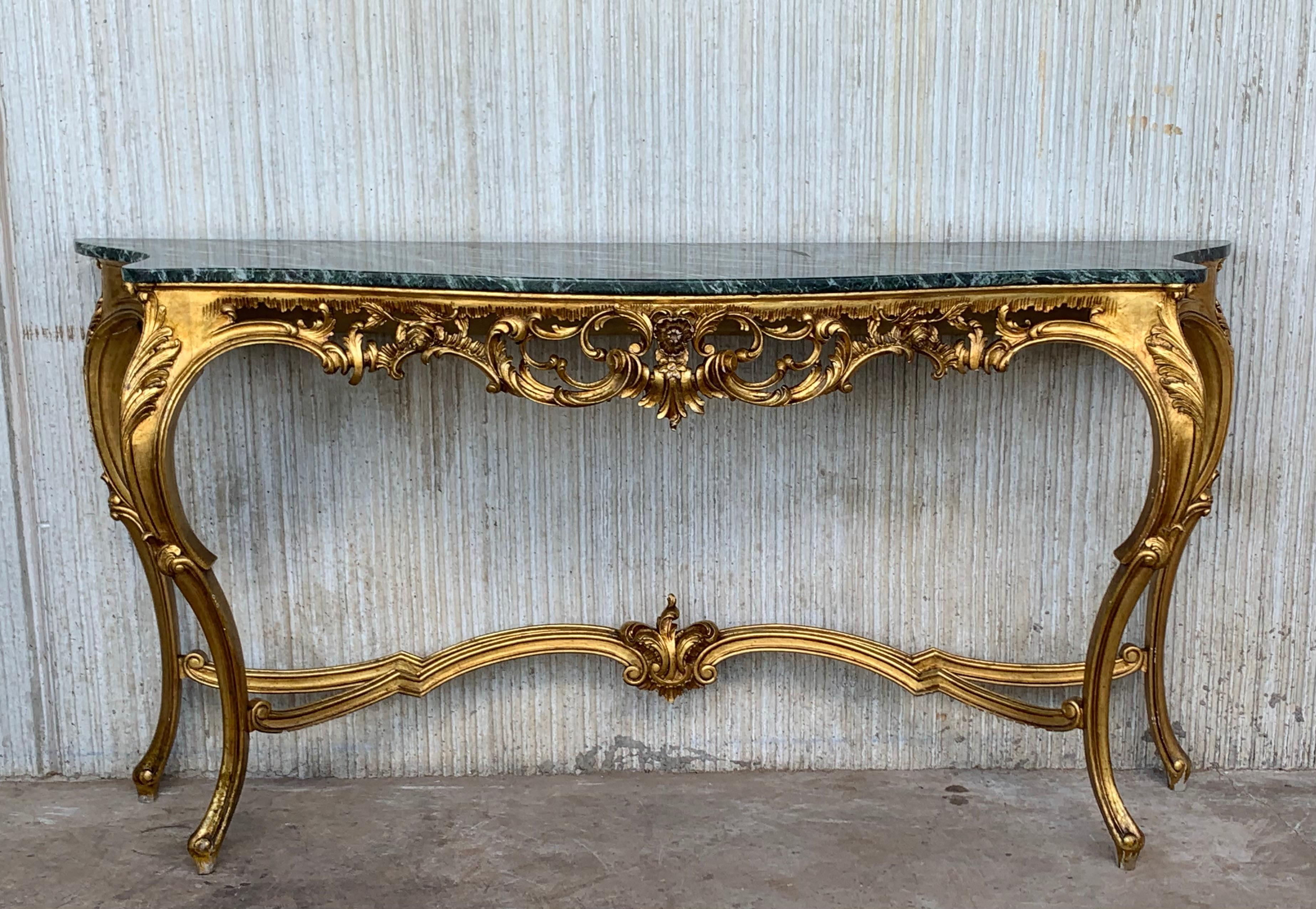 A magnificent and large scale Spanish 20th century Baroque style, ormolu and green marble freestanding console. The most impressive console is raised by elegant scrolled acanthus leaf feet below the powerful scrolled legs with richly carved flowers