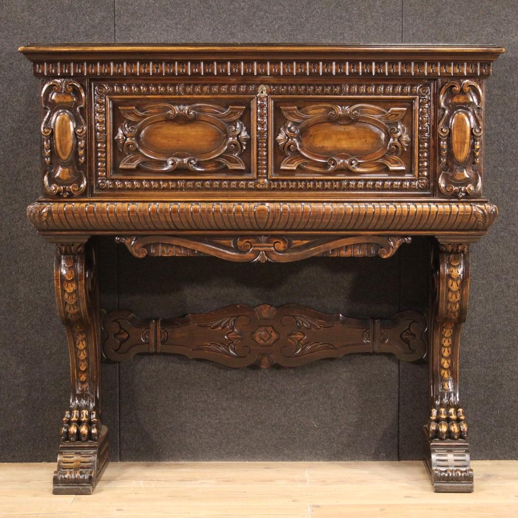 Baroque style French bar cabinet from the 20th century. Furniture richly carved in dark patinated oak wood, equipped with fall front and working key. Ideal cabinet to be placed in a living room or studio with internal compartment covered in fabric,
