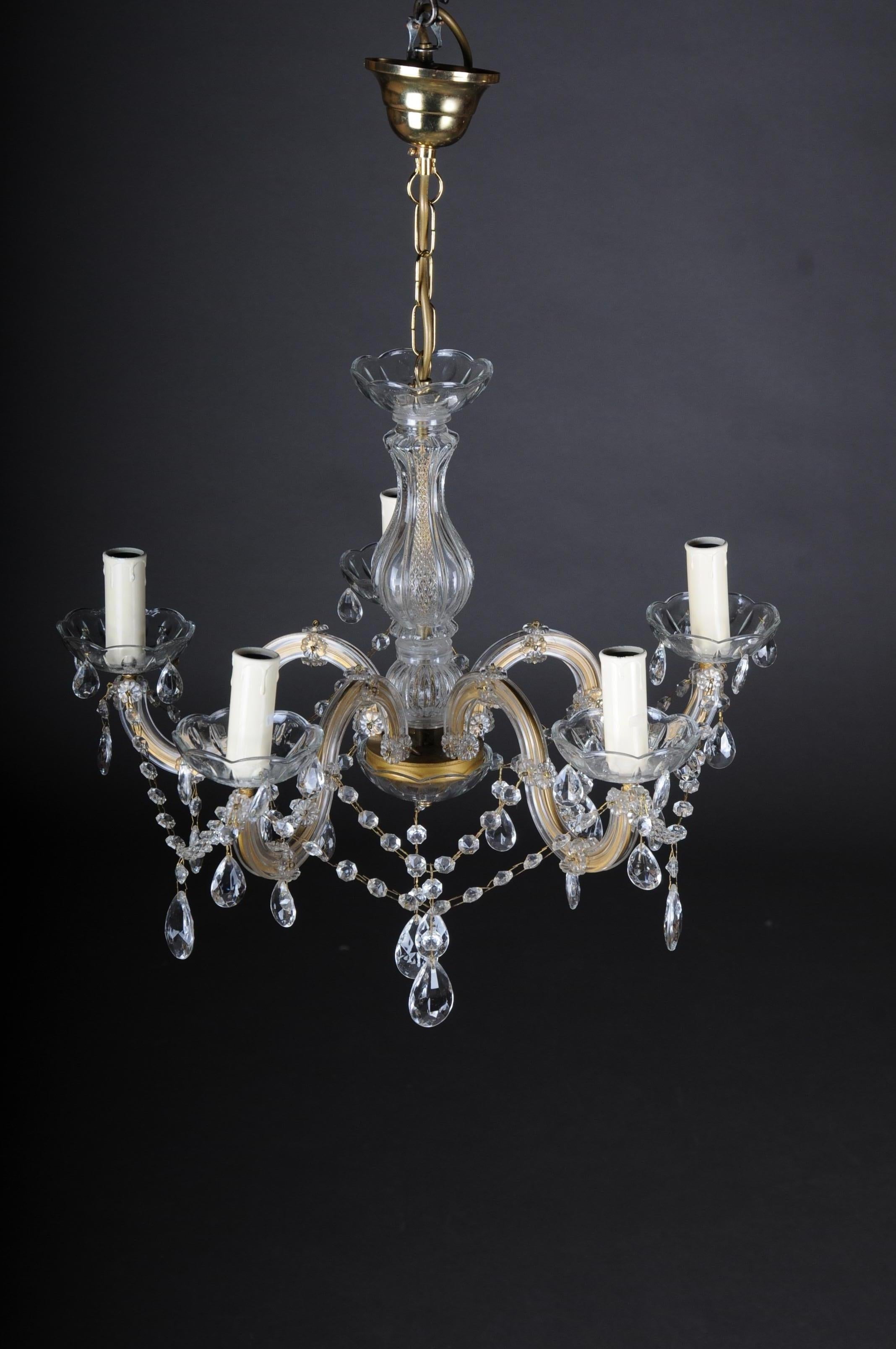 20th century beautiful Maria Theresia chandelier / lamp

Brass, chased. High baluster-shaped body. Five-armed lights, electrified with crystal hangings, richly faceted. Extremely decorative and high quality workmanship.

(F-121).