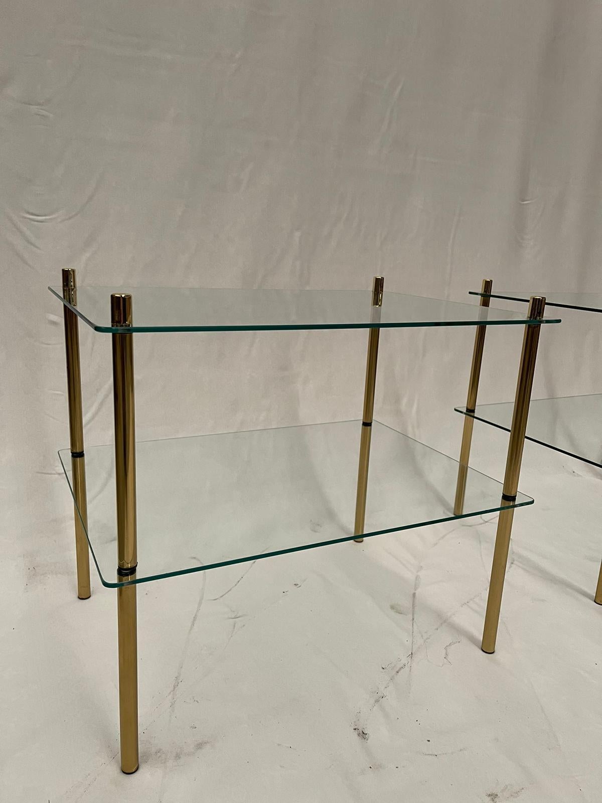 Pair of bedside tables created with gold colored brass and resistant glass. Suitable for any type of furniture that wants a touch of light and class.