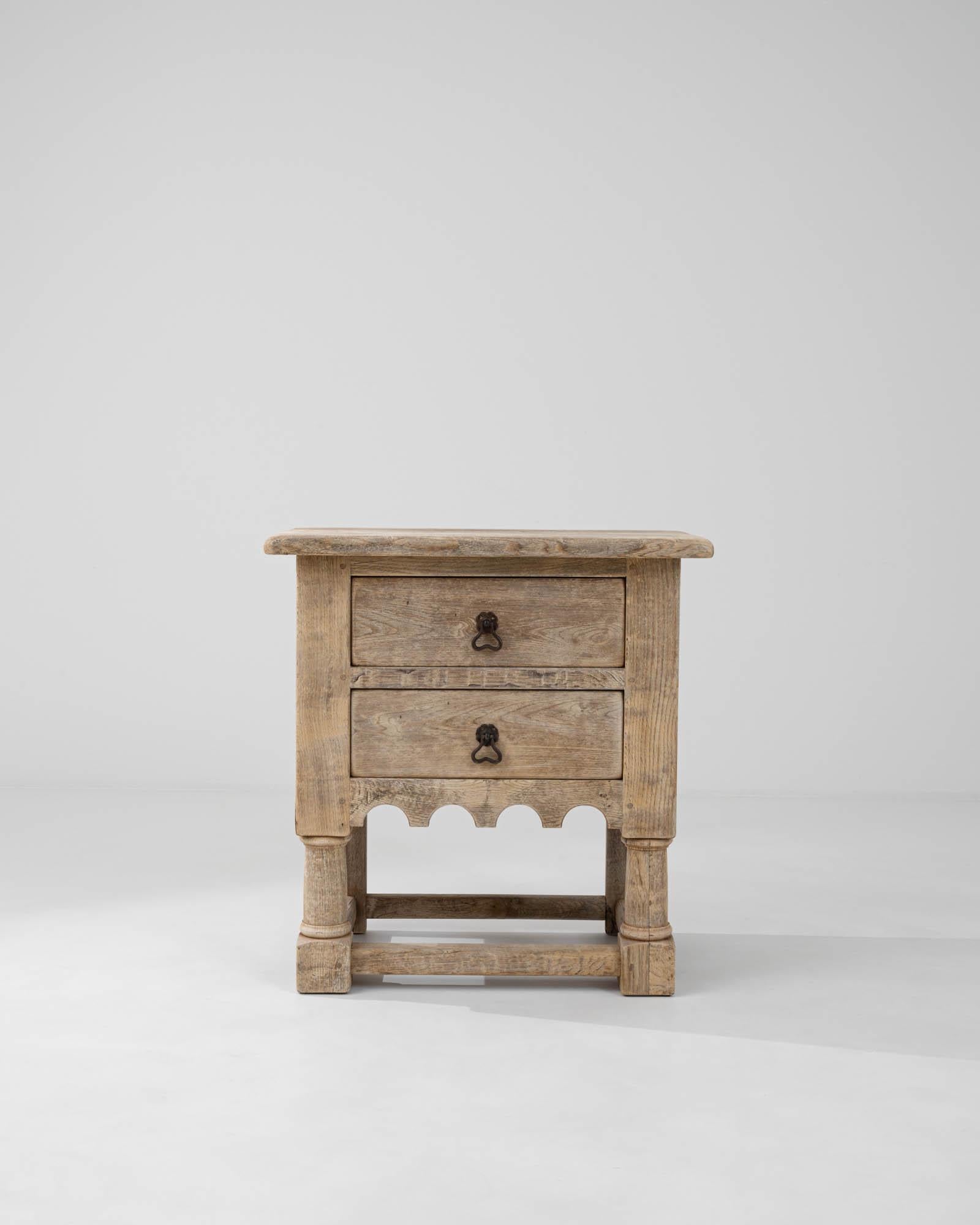 This 20th Century Belgian Bleached Oak Chest of Drawers exudes a timeless charm that complements any interior décor. Crafted from solid oak with a lovely bleached finish, this piece highlights the natural beauty and distinct grain of the wood,