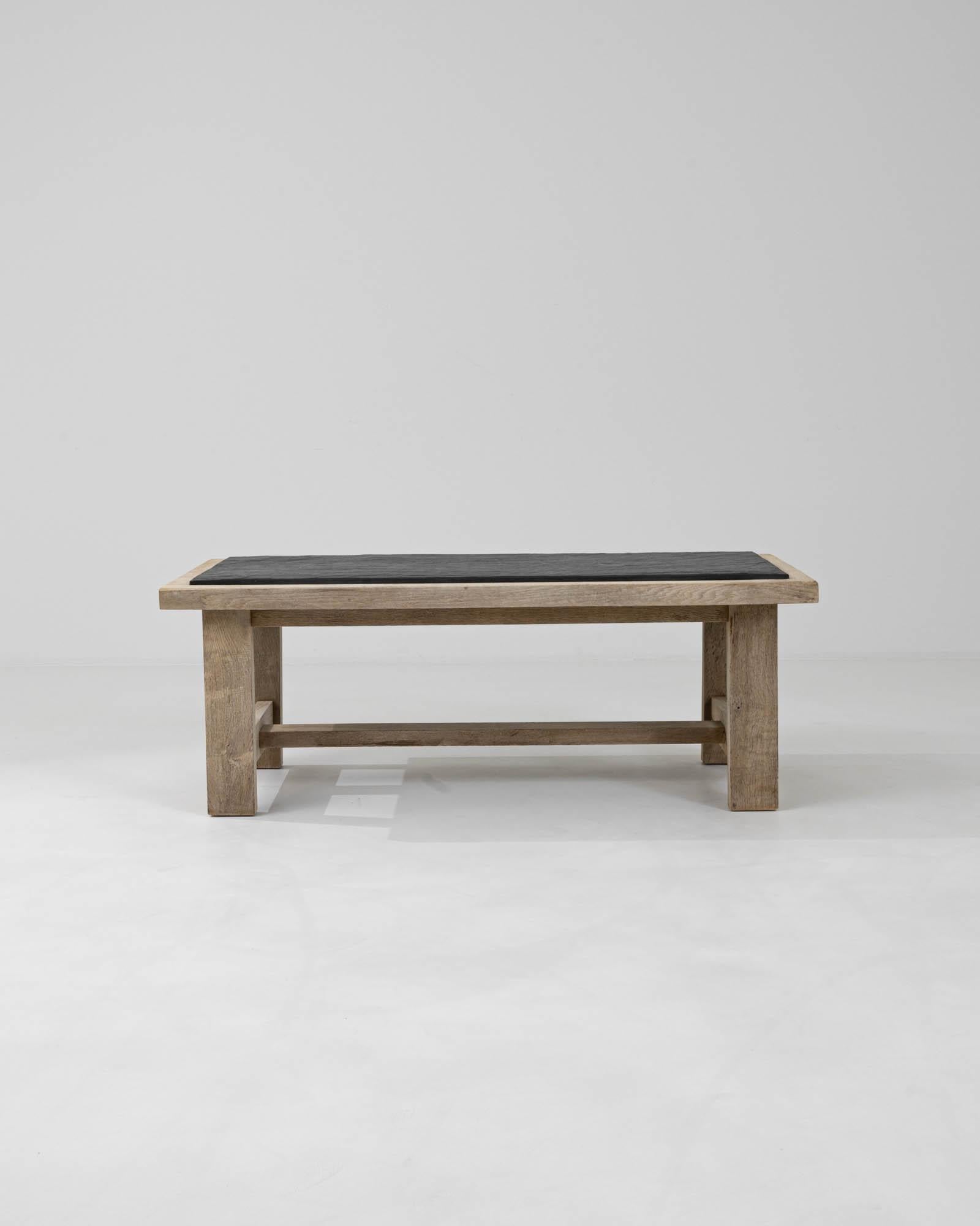 Discover the rustic charm and timeless elegance of this 20th Century Belgian Bleached Oak Coffee Table, featuring a stunning stone top. Meticulously crafted from bleached oak, its natural grain and weathered texture offer an air of antique