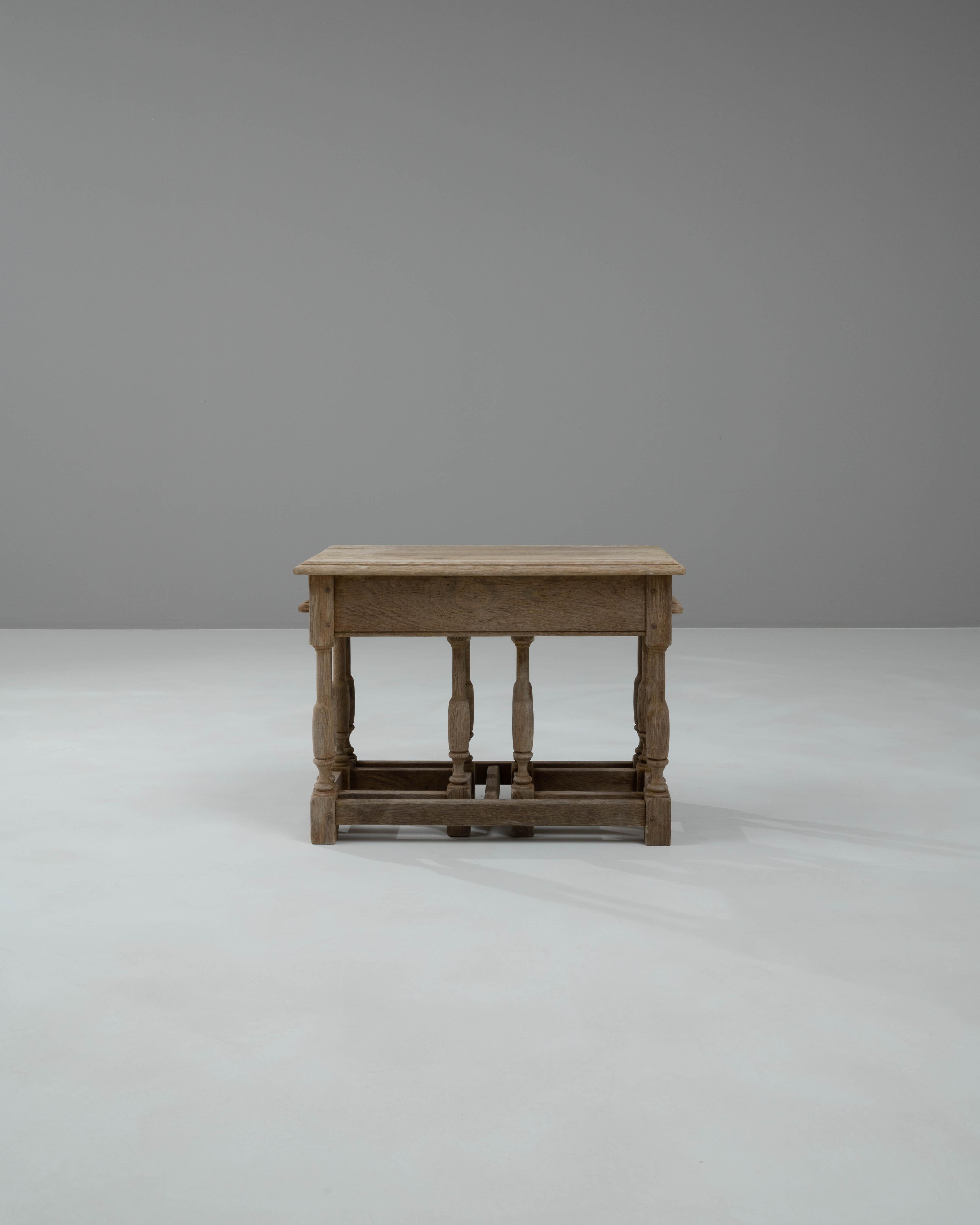 Enhance your home with the versatility and timeless elegance of this set of three 20th-century Belgian nesting tables. Crafted from exquisite bleached oak, each table showcases a unique yet harmonious design, featuring beautifully turned legs and a