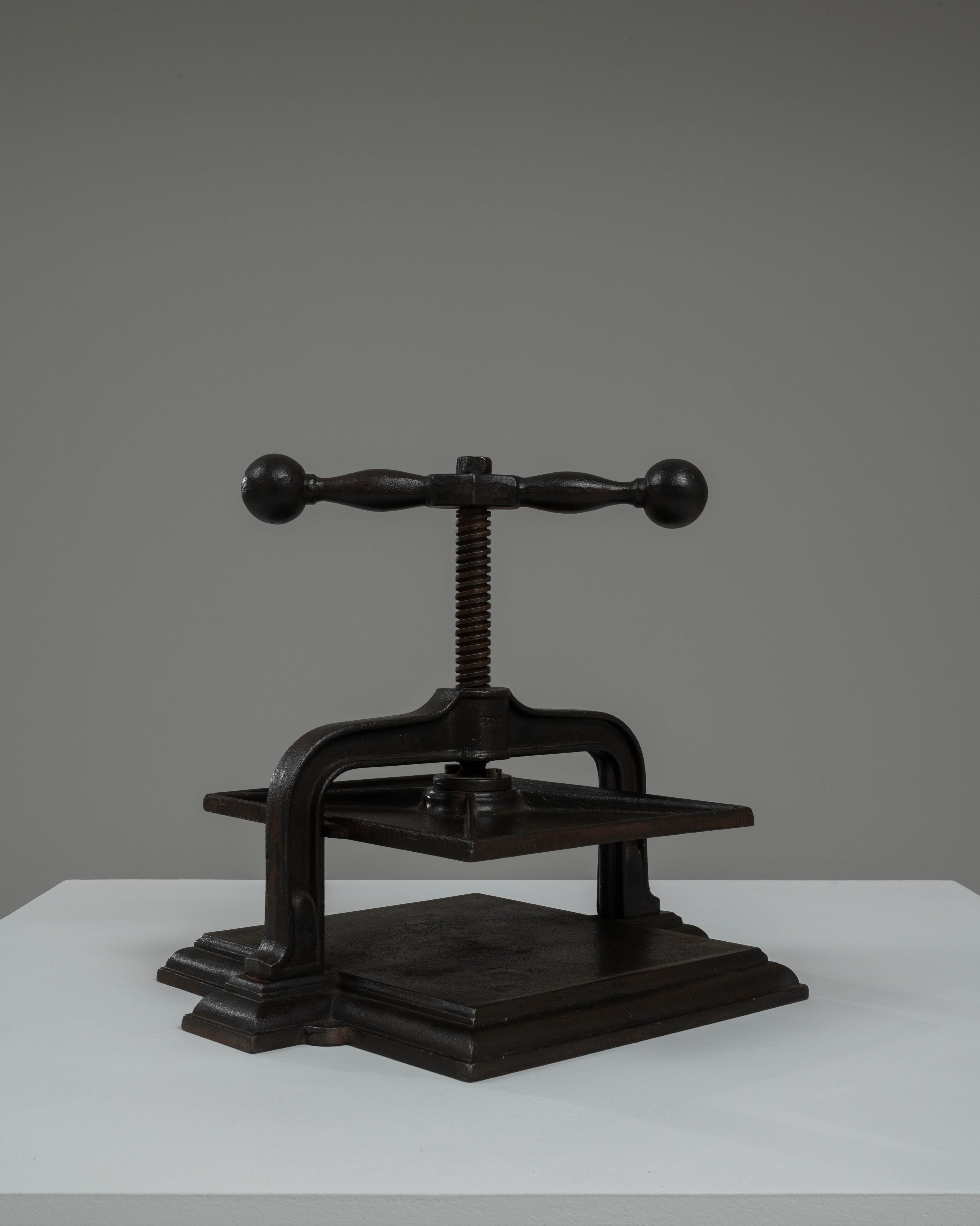 Discover the craftsmanship and enduring appeal of this 20th Century Belgian Cast Iron Press. This robust tool, crafted from high-quality cast iron, boasts a striking design that is as functional as it is decorative. Featuring a sturdy base and a